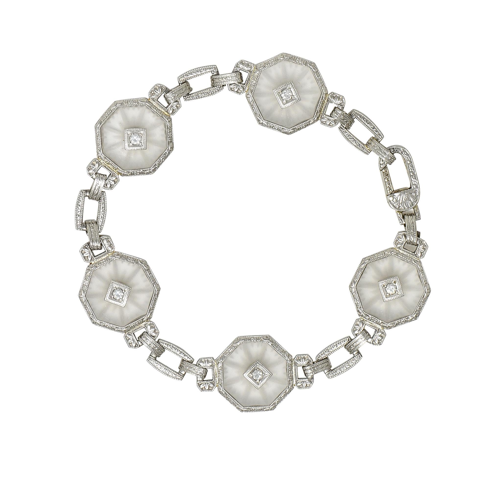 Comprised of pierced rectangular link chain featuring five hexagonal camphor glass stations
Measuring 13.0 x 13.0 mm - transparent with frosted matte finish and engraved burst motif
Each centering a single cut diamond - weighing approximately 0.15