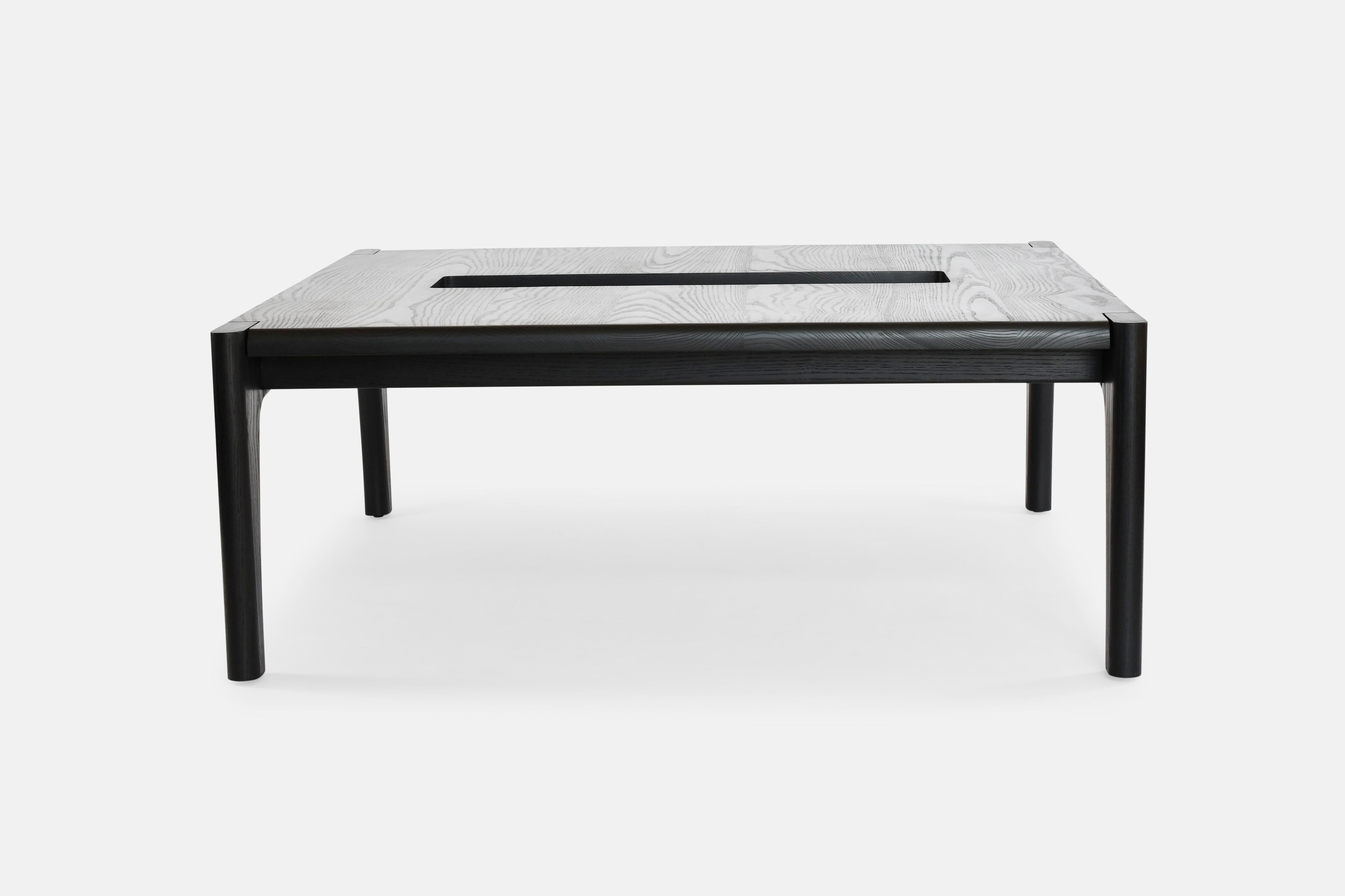The Tayo coffee table combines organic richness with mid-century lines creating a piece that could almost run on its own. The table features an aperture in the center as a two-tier focal point for book and accessory display. Great for dinner and a