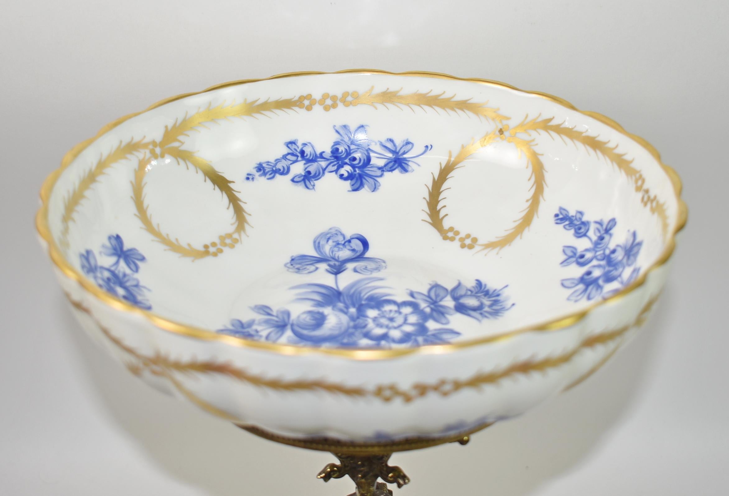 Tazza Brass Center Pedestal with Decorative Meissen Bowl. circa late 19th century. Meissen Porcelain bowl is decorative with blue flowers with gold swags and wreaths. Marked with hand painted crossed swords, ALLCO, and stamped France. The Tazza