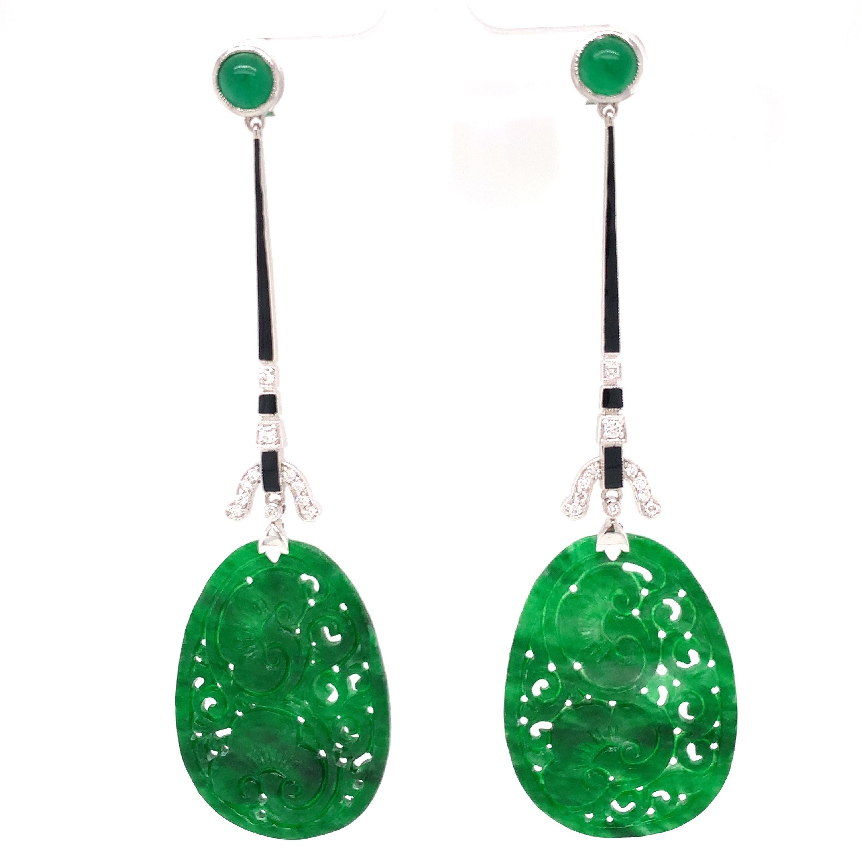 The contrast of nephrite jade, black enamel. and diamonds make these designer art deco earrings stand out. 8.88 carats of carved jade and .26 cttw  SI clarity H-I color in diamonds. Mounted 18 kt white gold. 10.44 grams. The black enamel highlights