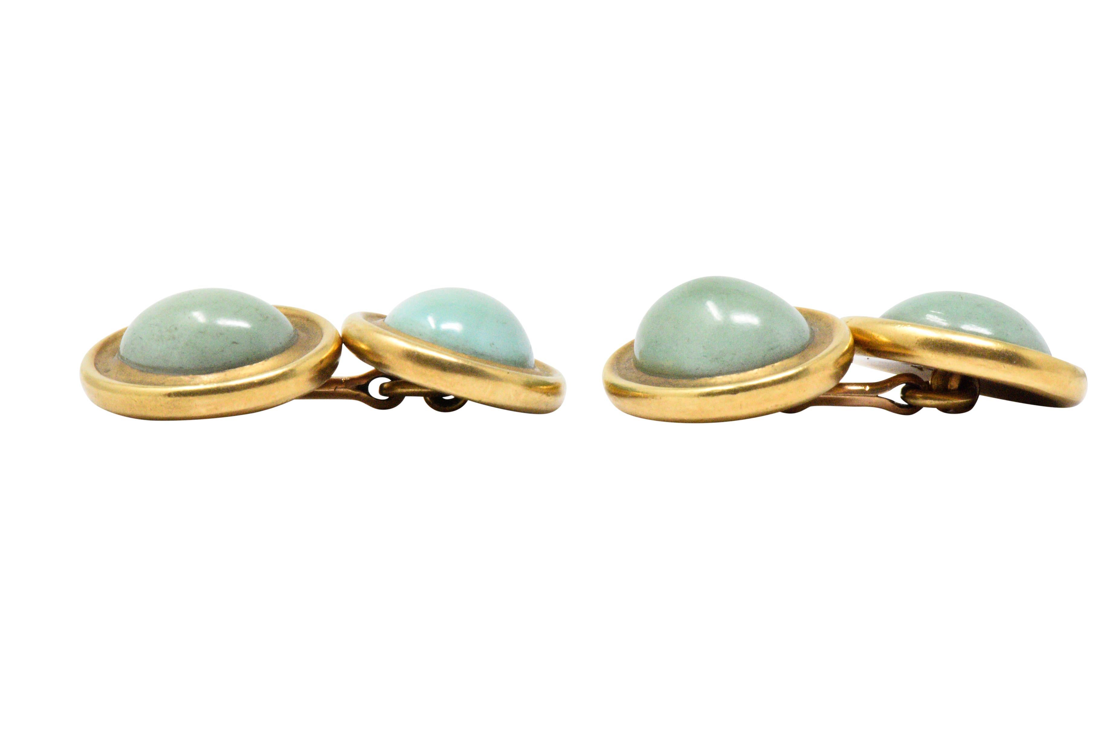 These handsome cufflinks, each with an oval cabochon turquoise on each side, measuring approximately 13.0 x 9.7 mm, light to medium blue-green with minor matrix and good luster

The turquoise are bezel set in rich 18 karat gold 

Bar link style