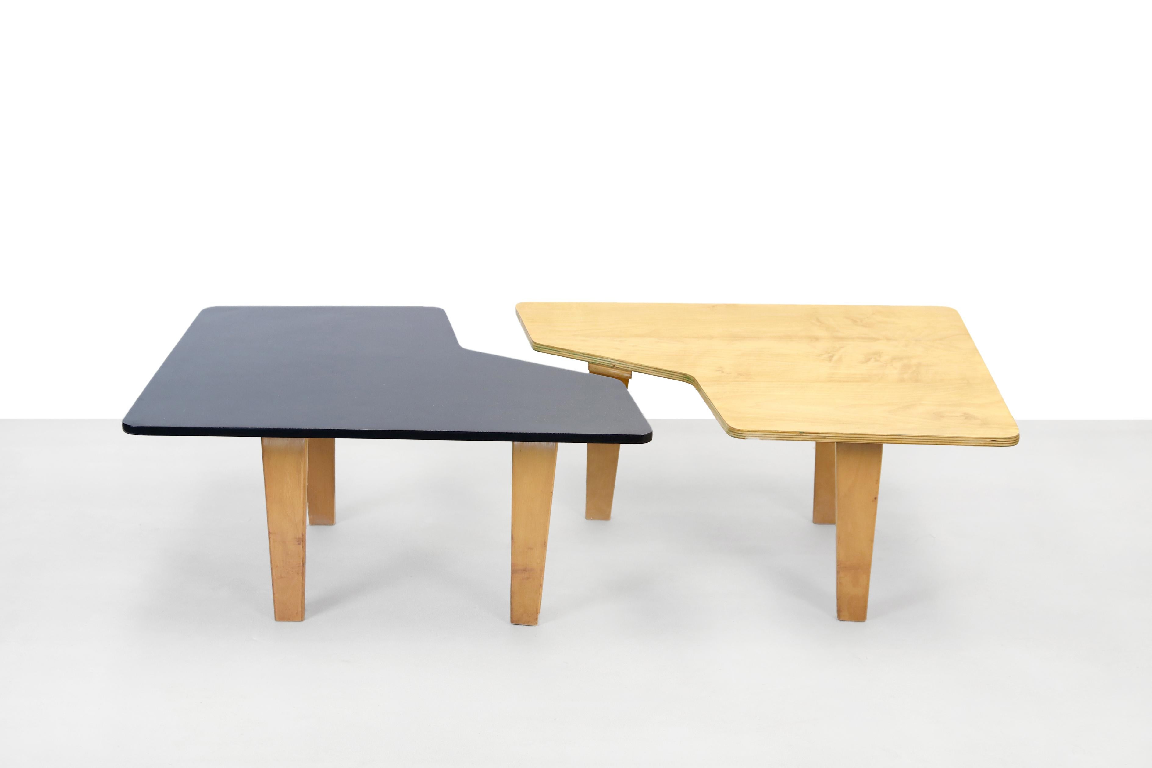 Beautiful set of two puzzle-shaped tables that together form an elongated coffee table. These tables are designed by Cees Braakman and produced by Pastoe in the 1950s in Utrecht, the Netherlands. They are part of the Combex series which was one of
