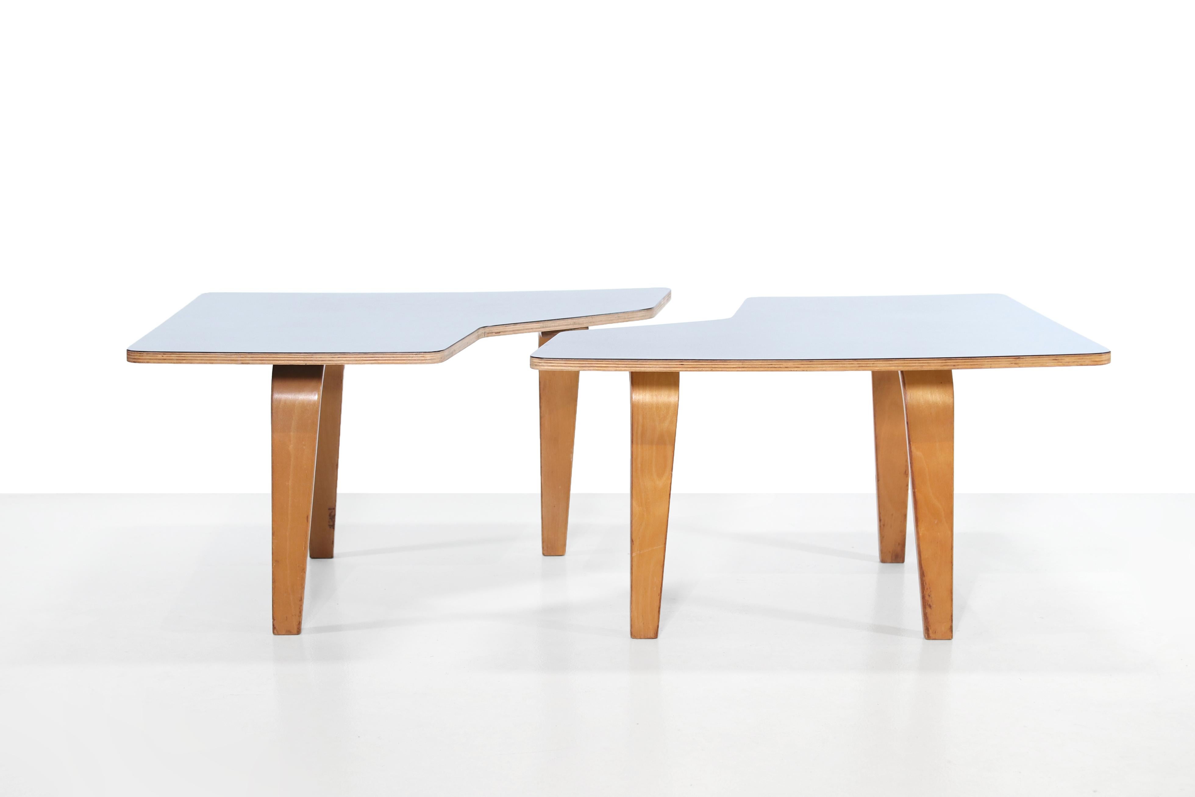 Beautiful set of two puzzle-shaped tables that together form an elongated coffee table. These tables were designed by Cees Braakman and produced by Pastoe in the 1950s in Utrecht, the Netherlands. They are part of the Combex series which was one of