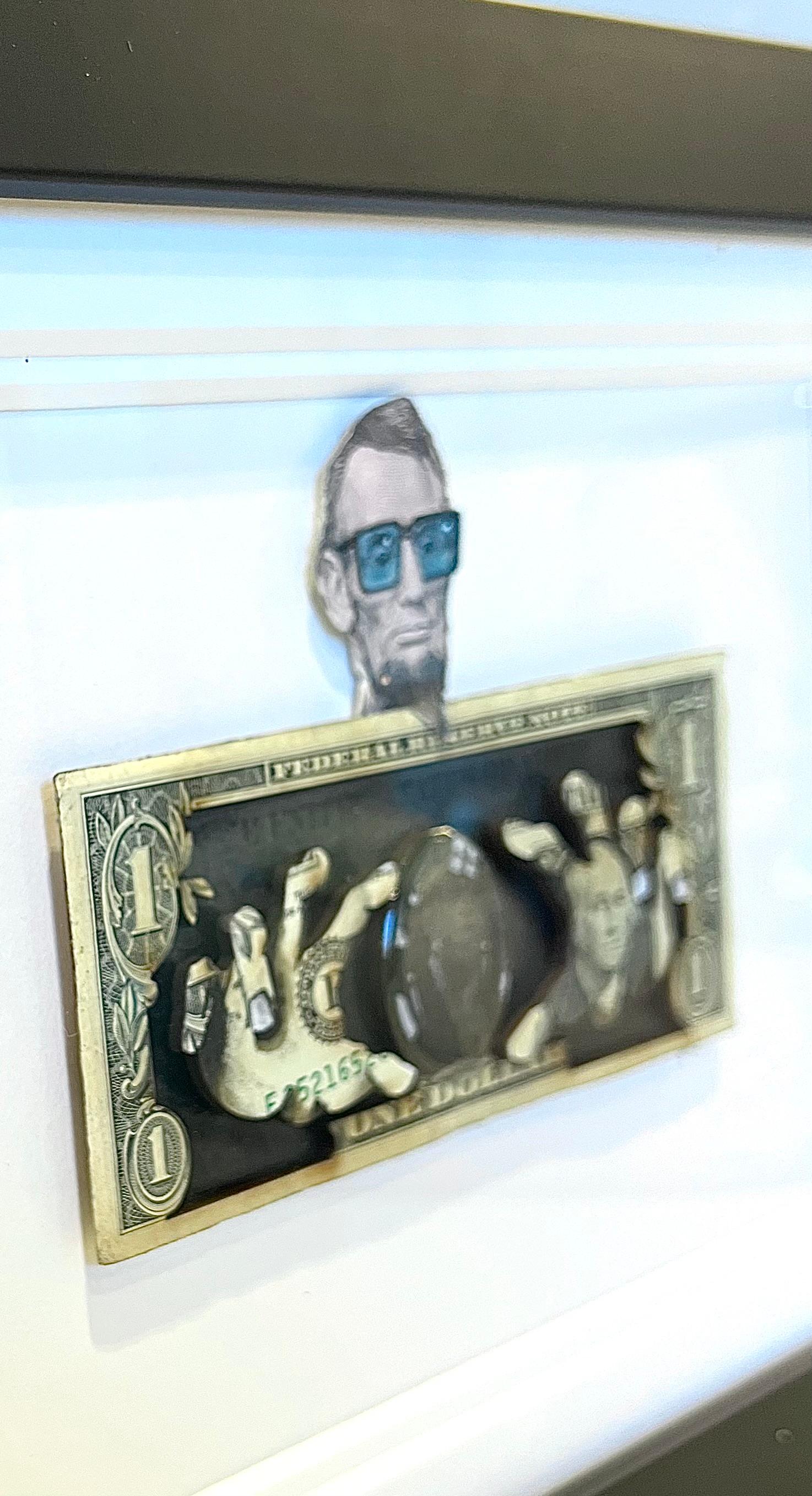 This is a 1/1 original currency with wood cutout framed -  It's all hand done with spray paint and acrylic and pencil on currency,  framed with non glare glass. 

TBOY is a British artist who's meteoric rise has put him on the map worldwide.  His
