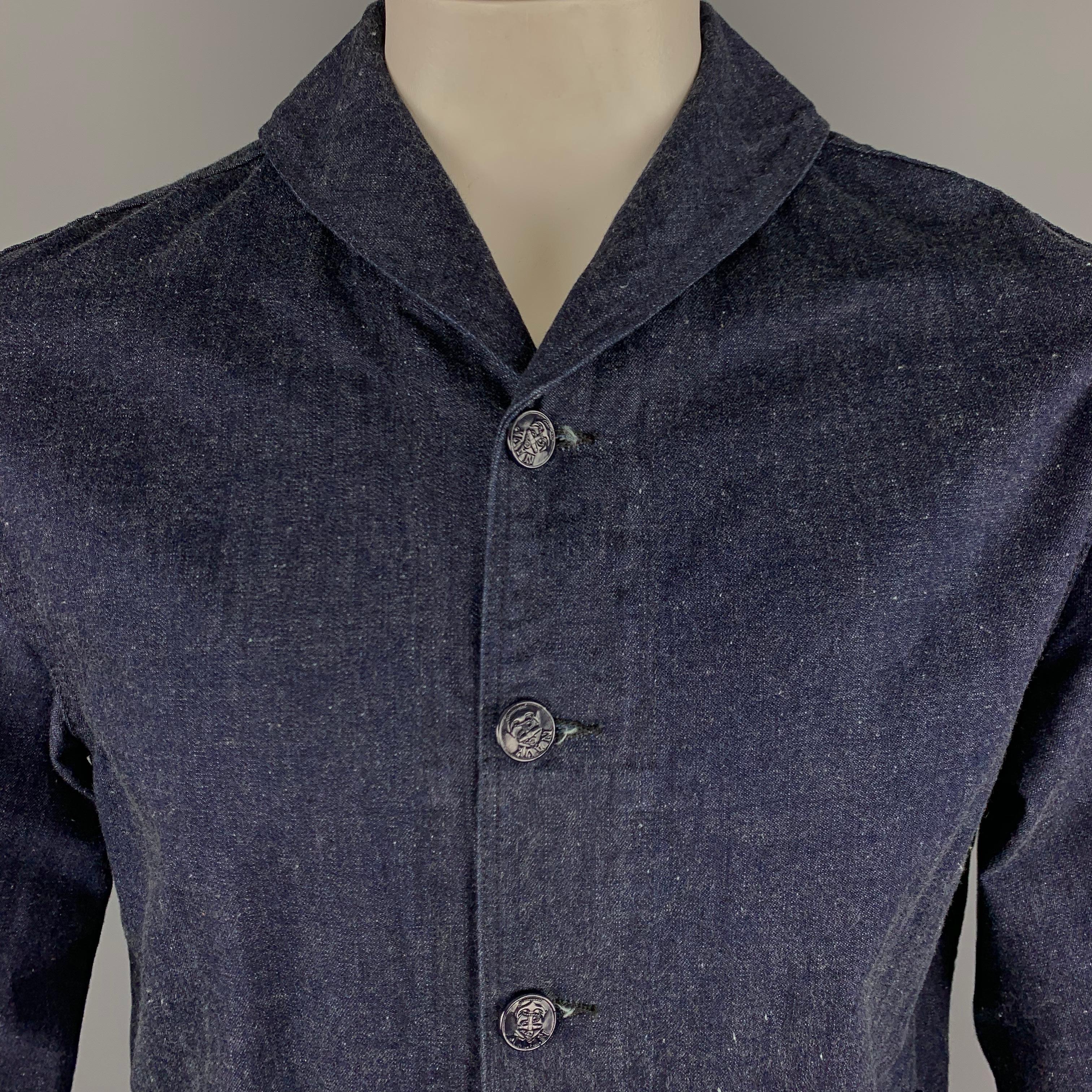 TCB Jeans Jacket comes in an indigo tone in a solid cotton material, with a shawl collar, buttoned front, embossed buttons, patch pockets, unbuttoned cuffs, unlined, in a 