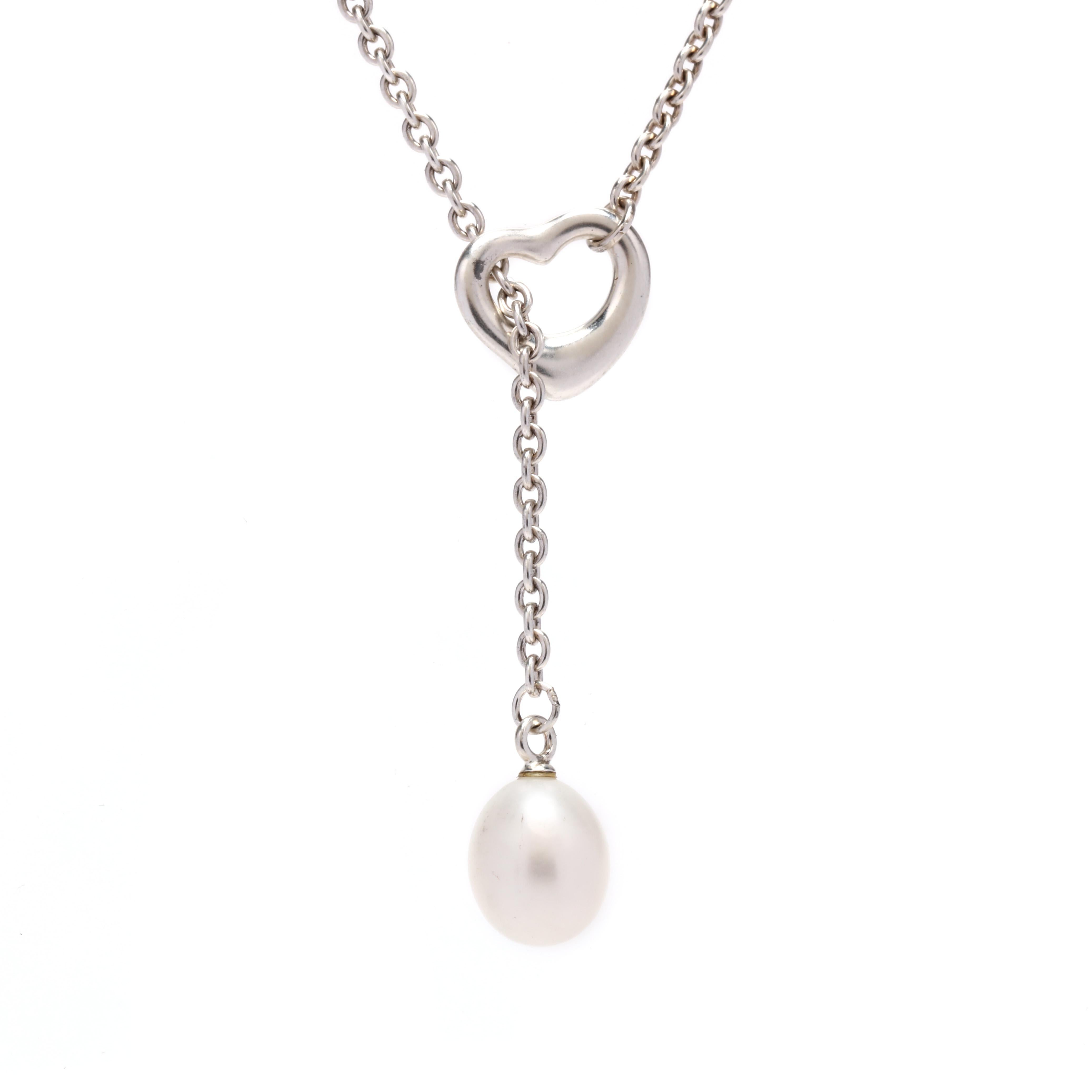 A sterling silver pearl heart lariat necklace by Tiffany and Company. This necklace features a cable chain with an open heart at one end with the other pearl end going through it to create a lariat and with a spring ring clasp.



Stone:

- pearl, 1
