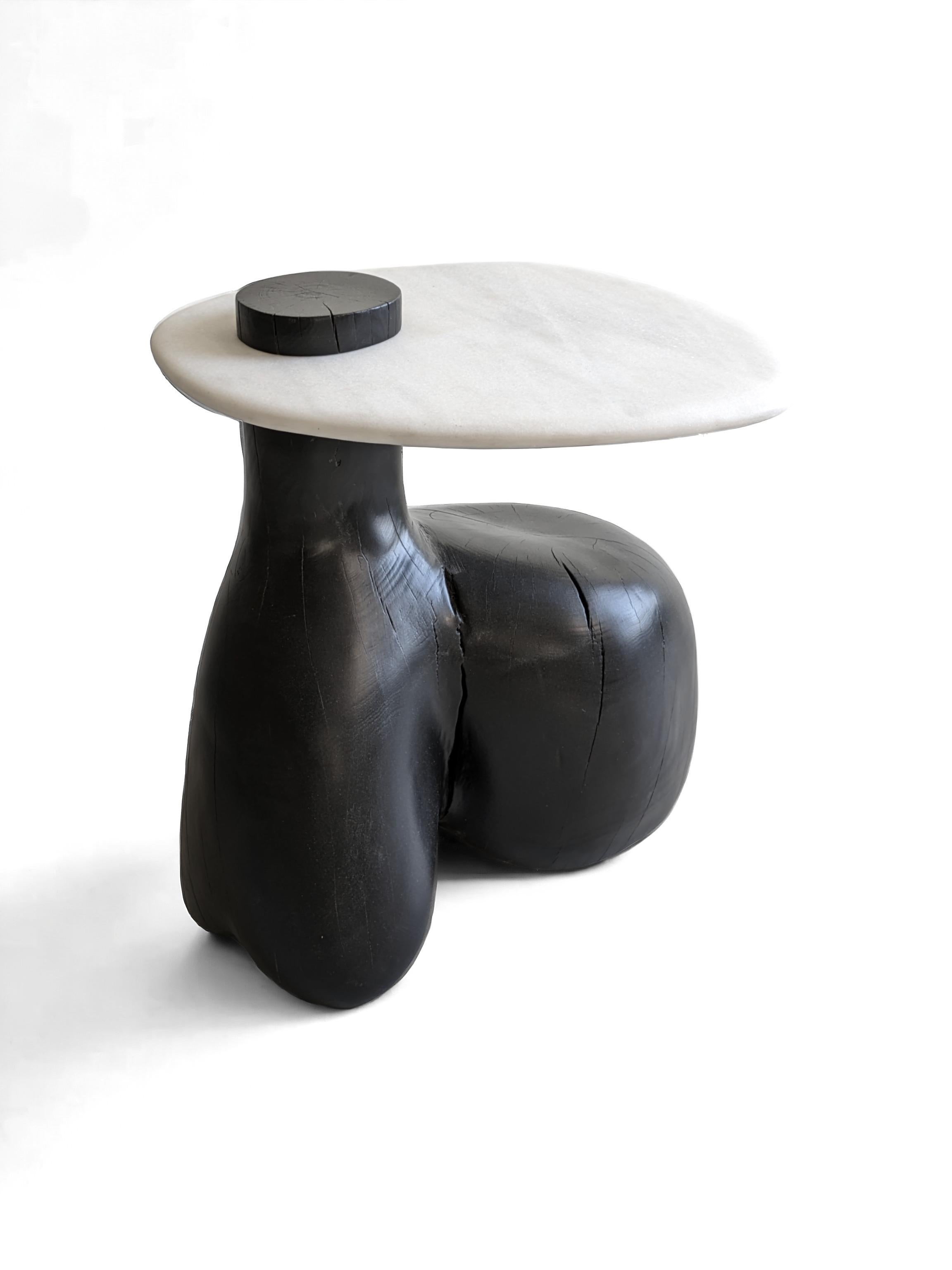 Mesa auxiliar 1 Colección Tea 1750 by AMBER x IÑIGO CALLEJA
Dimensiones: An 50 x Pr 45 x Al 50 cm. 
Materiales: Base de viga de té antigua, carbonizada y teñida de negro. Encimera de mármol crema marfil.

Iñigo Calleja es un ingeniero, diseñador y