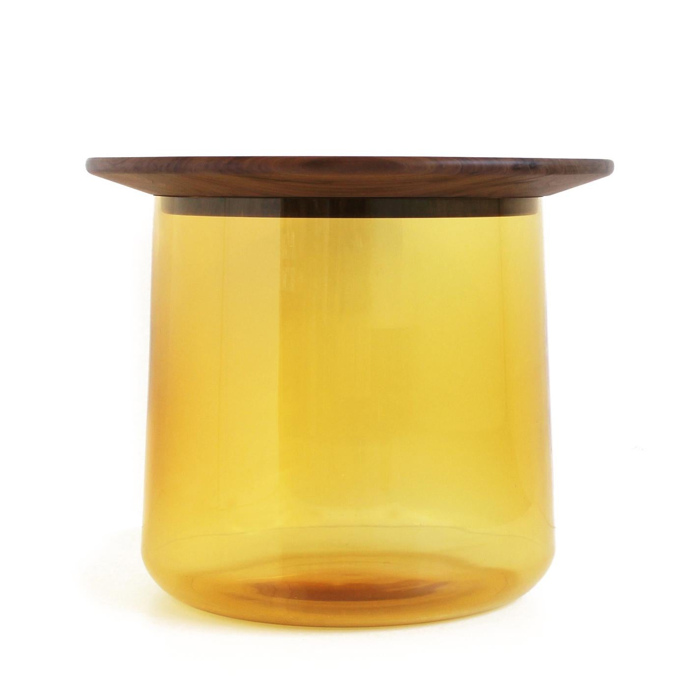 Cette étonnante table d'appoint est composée d'un grand vase inférieur en verre coloré (qui peut servir de récipient ou d'espace de rangement), et d'un plateau en noyer massif 