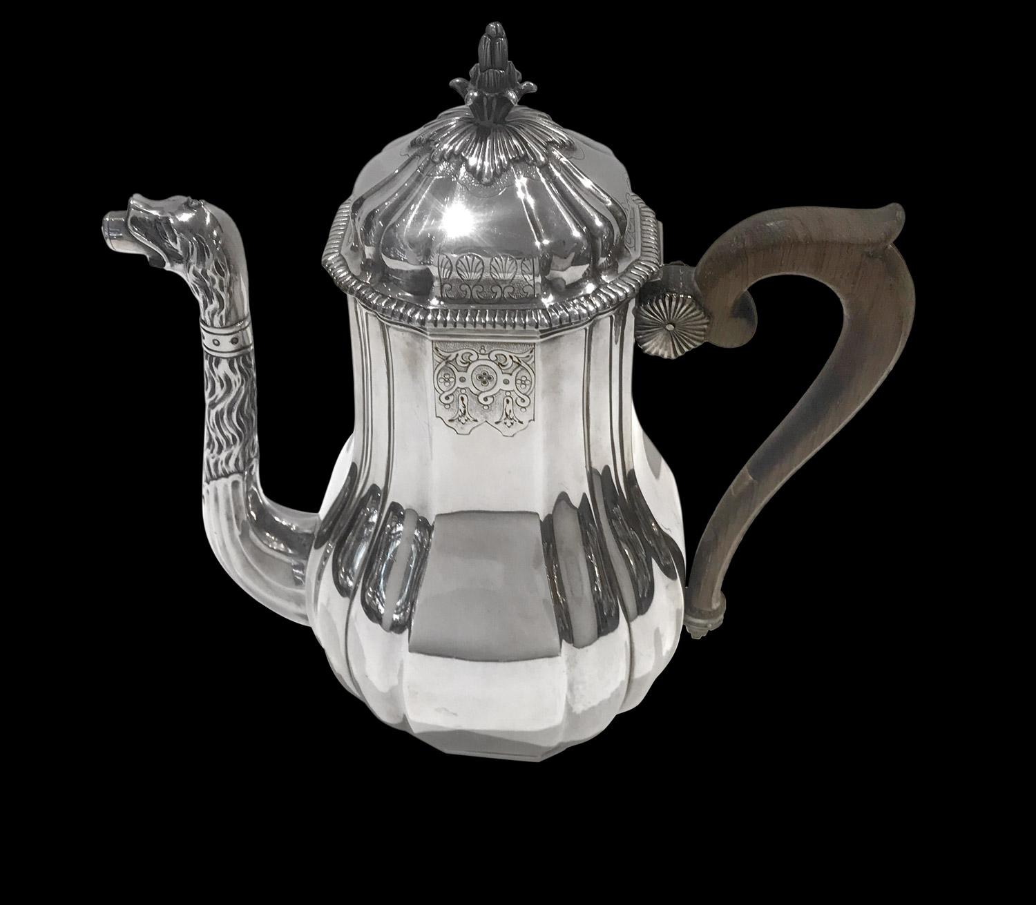 Tea and coffee set in sterling silver by the French silversmith Falkenberg composed of 4 objects: one teapot, one coffee pot, one sugar pot and a milk pot.
Pieces are in pear-shaped form with ribbing. Tea-pot and coffee pot have a curved dog-shaped
