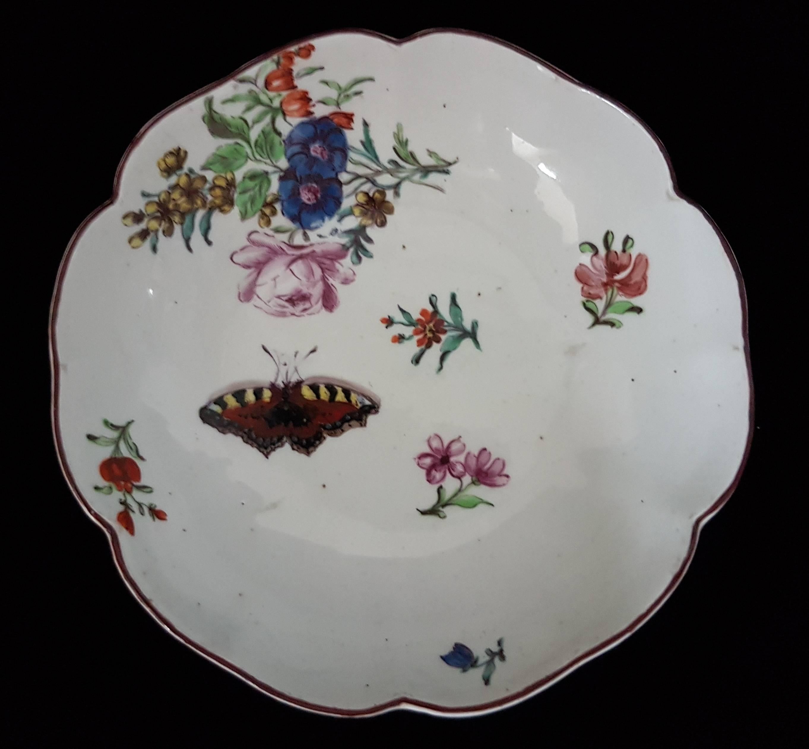 From early in the red anchor period, a fluted tea bowl and saucer, exquisitely painted with flowers and insects.