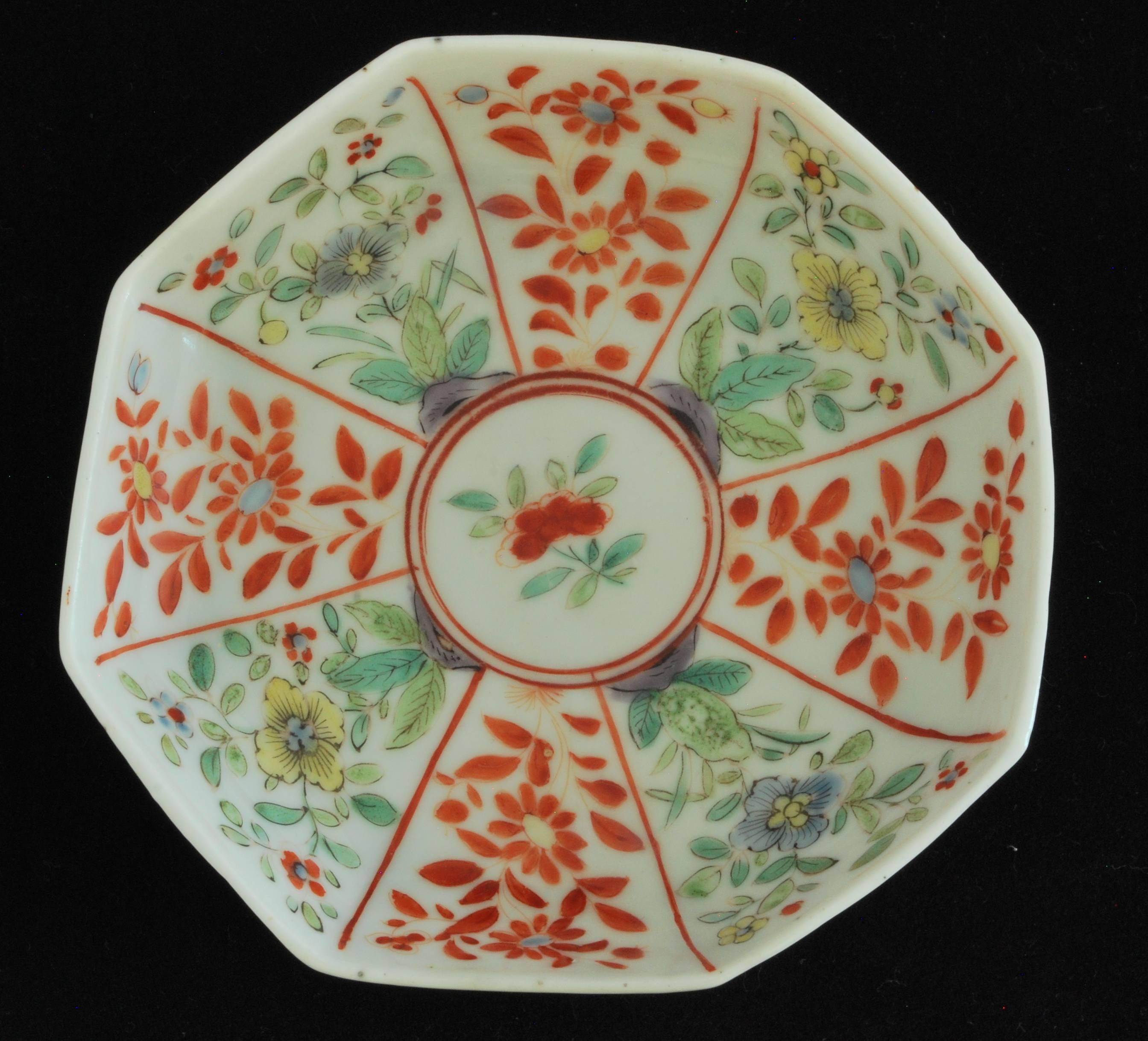 Octagonal tea bowl and saucer, attractively decorated using the Famille Verte palette.

Raised Anchor mark to saucer. 
 
The Famille Verte palette is a specific color palette used in Chinese porcelain during the Ming and Qing dynasties. The palette
