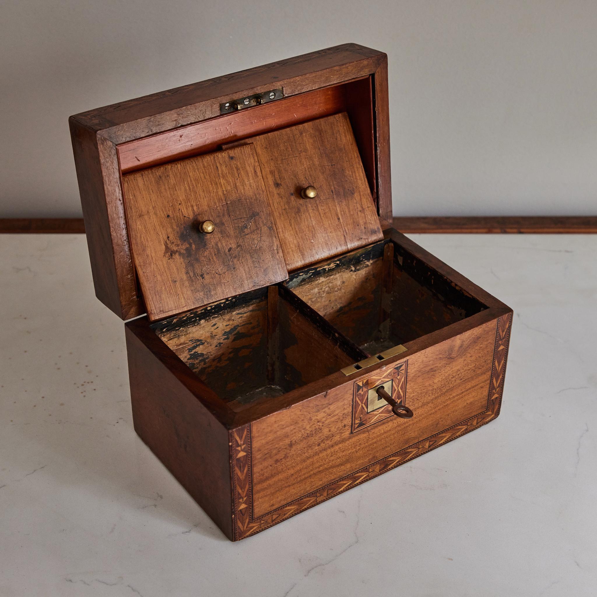 Inlaid tea caddy box in walnut and mahogany.