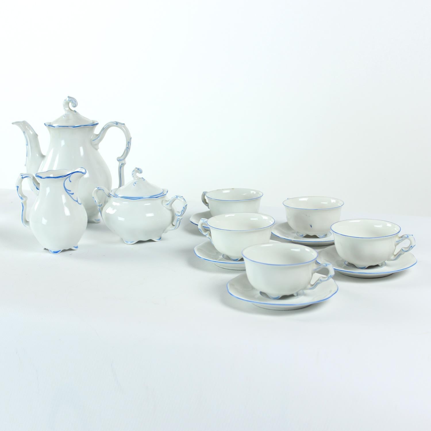 Beautiful set of tea /coffee set in white porcelain by Pirkenhammer Brezova, 1950s. Original label visible on each piece. The set is of a white porcelain with blue details on rims. This little details makes the set even more beautiful and elegant.