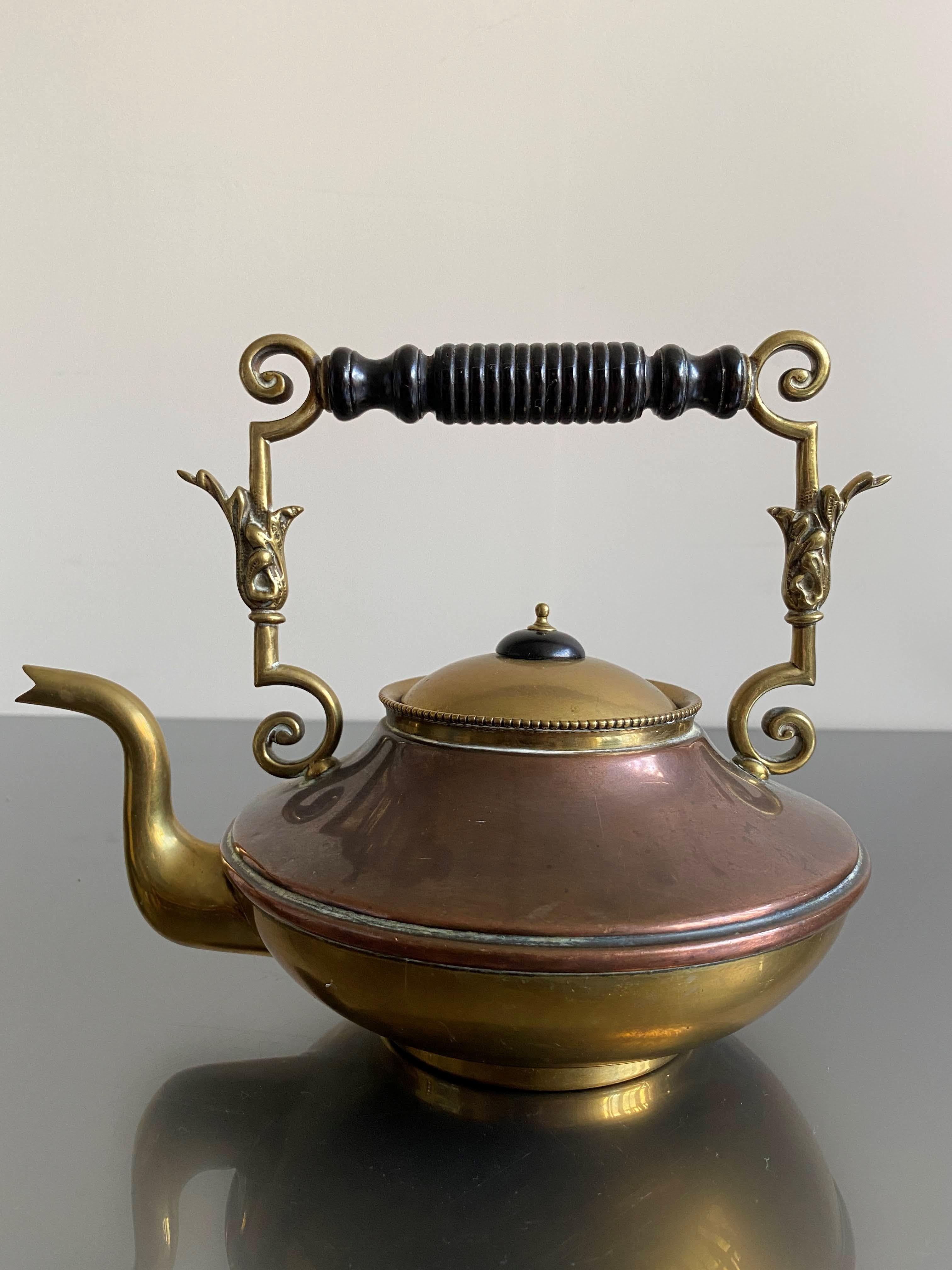 An early 20th Century brass and copper kettle with an ebony handle by William Soutter & Sons. A firm founded in 1760 but ceased manufacturing in 1928. Stamped with their trademark underside. 

Good condition.

Circa 1910

Country of origin England.