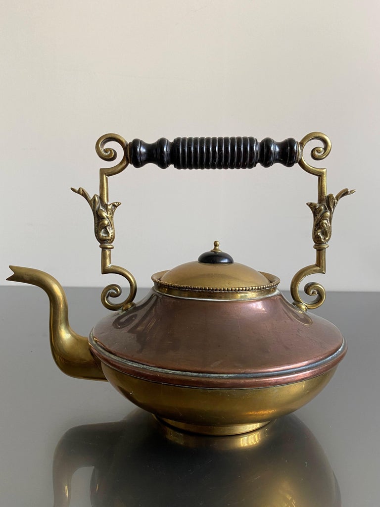 An early 20th Century brass and copper kettle with an ebony handle by William Soutter & Sons. A firm founded in 1760 but ceased manufacturing in 1928. Stamped with their trademark underside. 

Good condition.

Circa 1910

Country of origin