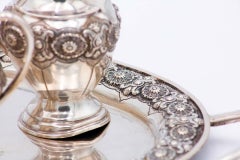 Tea service in embossed silver with floral motifs