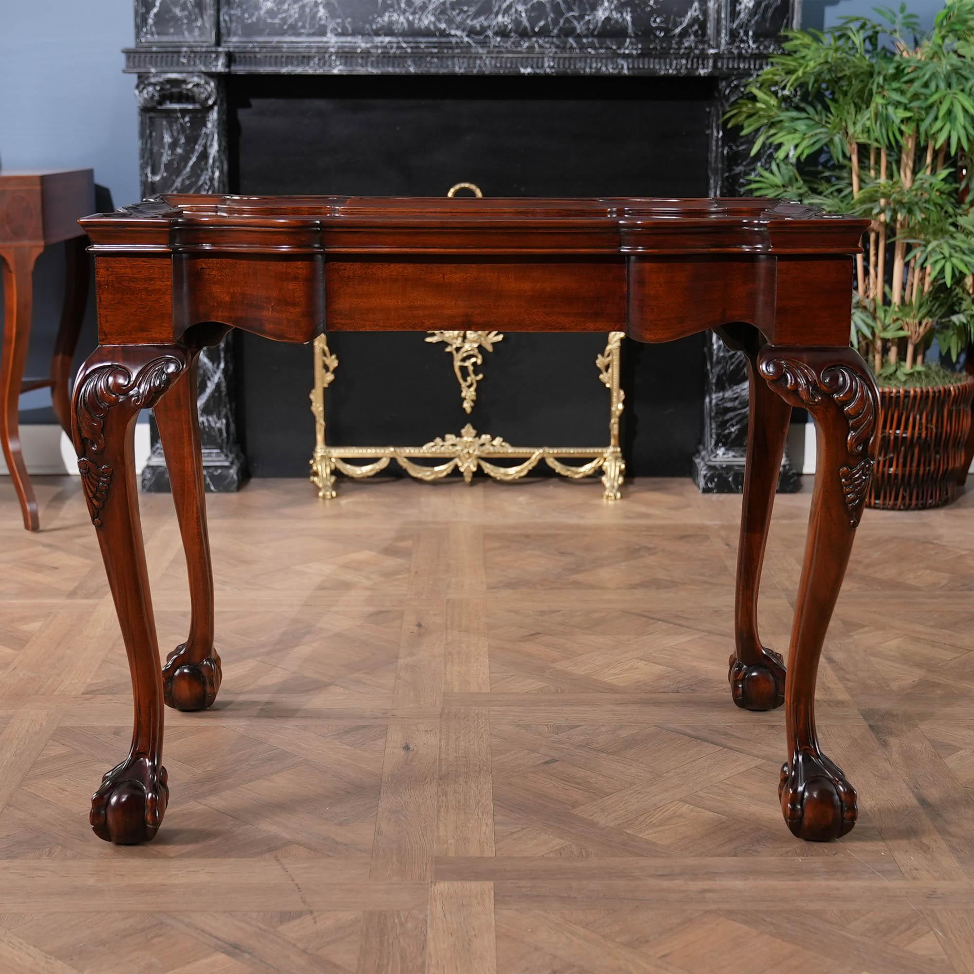Designed after an 18th Century New England style Tea table this high quality antique reproduction has fantastic hand carved details all the way from the molding along the top of the table down to the generous sized hand carved ball and claw style
