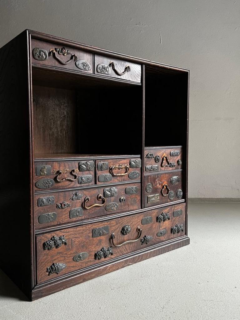 Japanese tea cabinet decorated with Samurai Sword Fittings (Menuki). Heavy item.

Additional information:
Country of manufacture: Japan
Period: Late 19th/early 20th century
Dimensions: 59 W x 25 D x 62 H cm
Condition: Good vintage condition; some