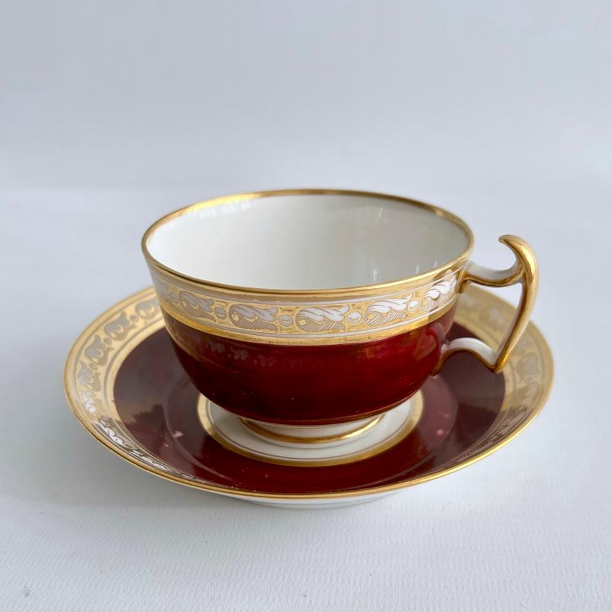 This is a beautiful true trio made by Barr, Flight & Barr, consisting of a teacup, a coffee can and a saucer. The set has a deep maroon ground and a very gracious gilt neoclassical band around the rims.

In the early 19th Century cups and saucers