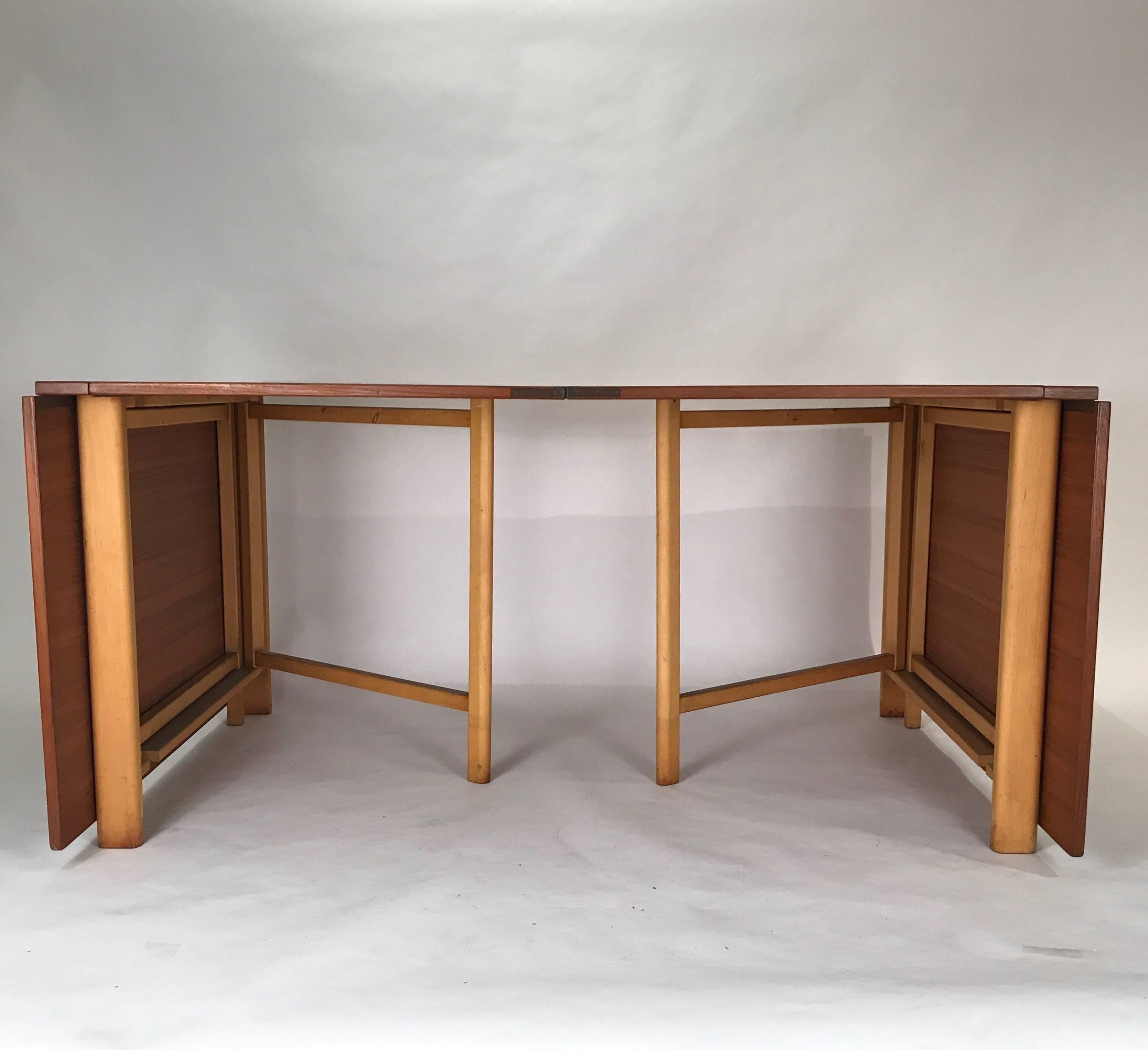 Fantastic drop leaf and accordion fold extension table designed by Bruno Mathsson for Karl Mathsson. This is the wider version of this table that was produced. Made in Sweden. Teak top with gorgeous beech legs.
Fully extended is 110