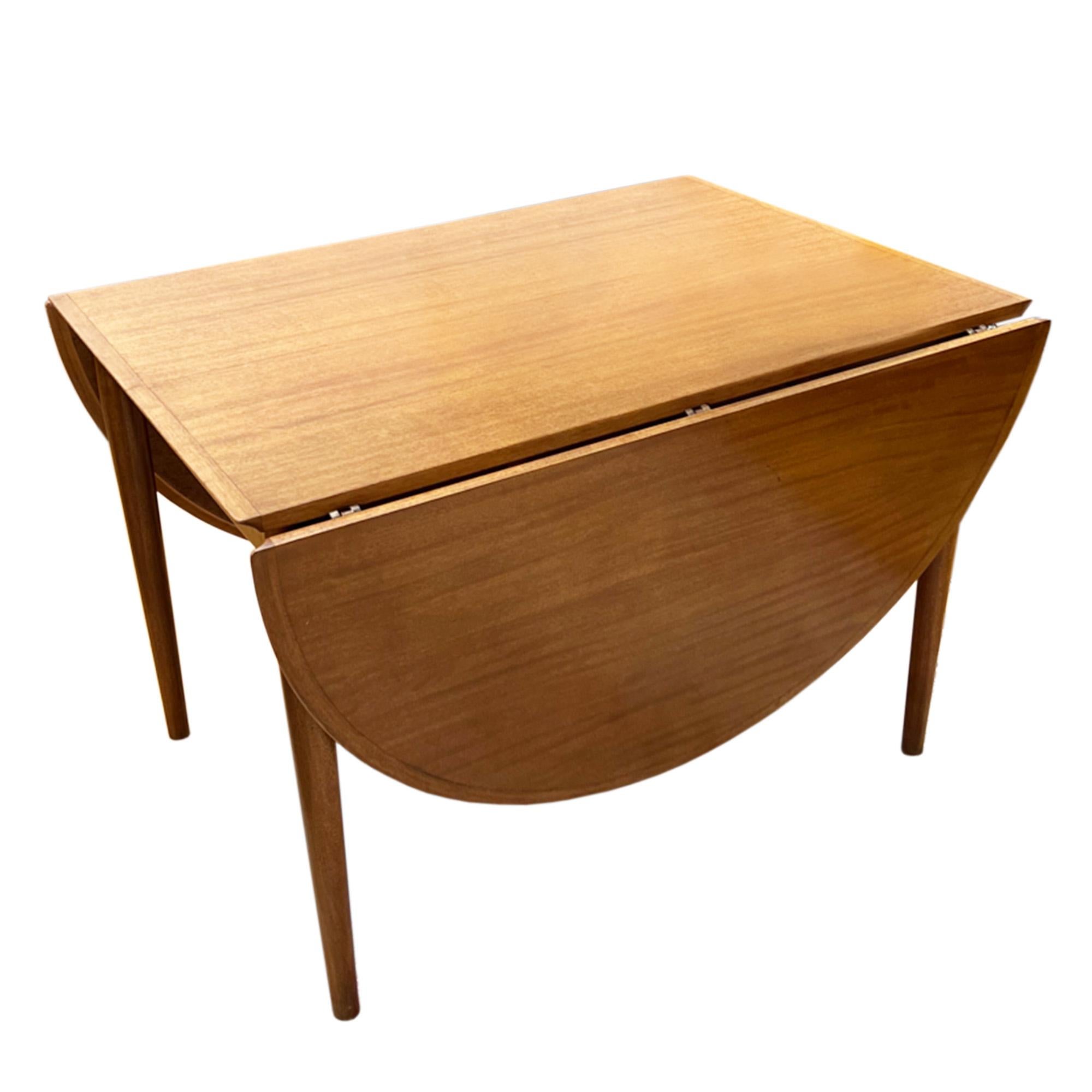This is an excellent example of Danish midcentury furniture design.

This extendable dining table can be set at three different lengths with each leaf measuring 55cm long. The table can be 180cm, 235cm or 290cm long. 

Designed by Arne Vodder, this