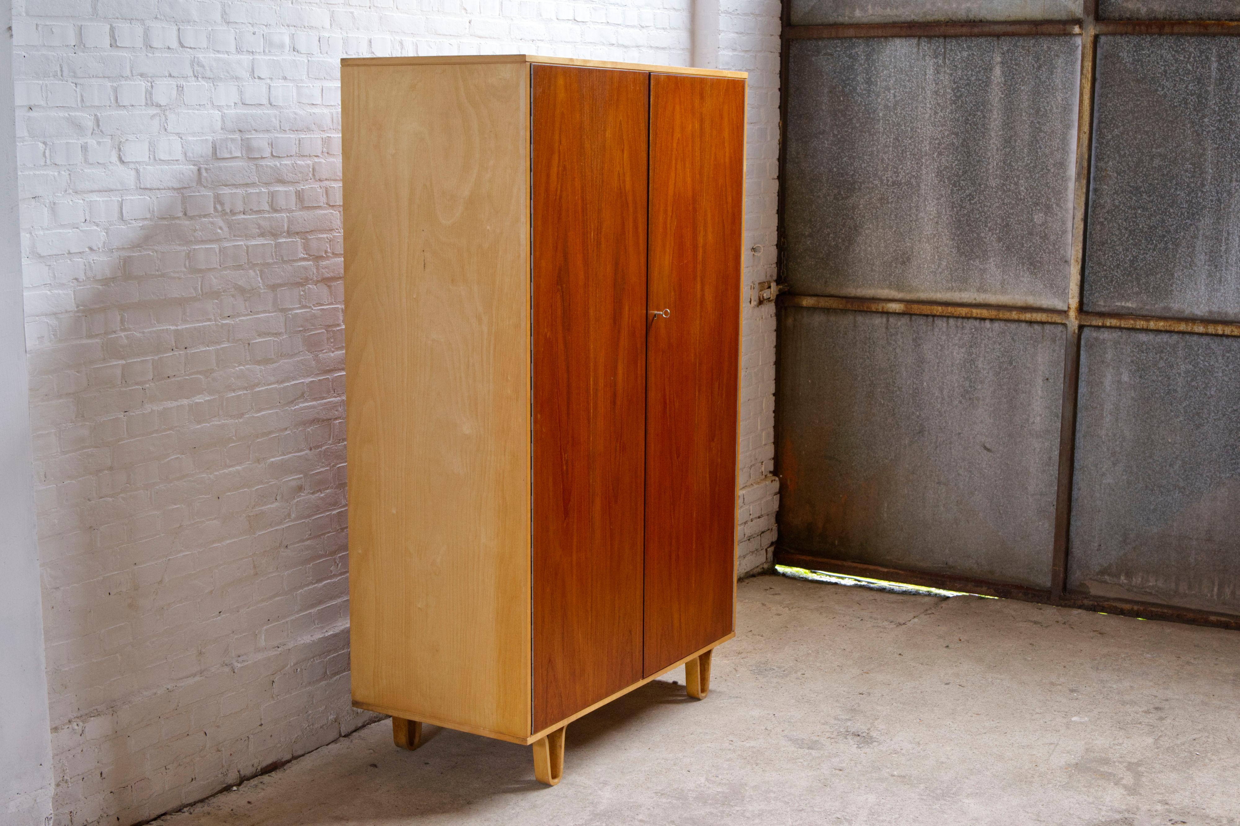 A mid-century wardrobe 'Model KB03' with the deluxe option of teak doors marked with model number 'KB33', designed by Cees Braakman in the 1950s and manufactured by Pastoe in the Netherlands.

This is a rare example in the birchwood series with more