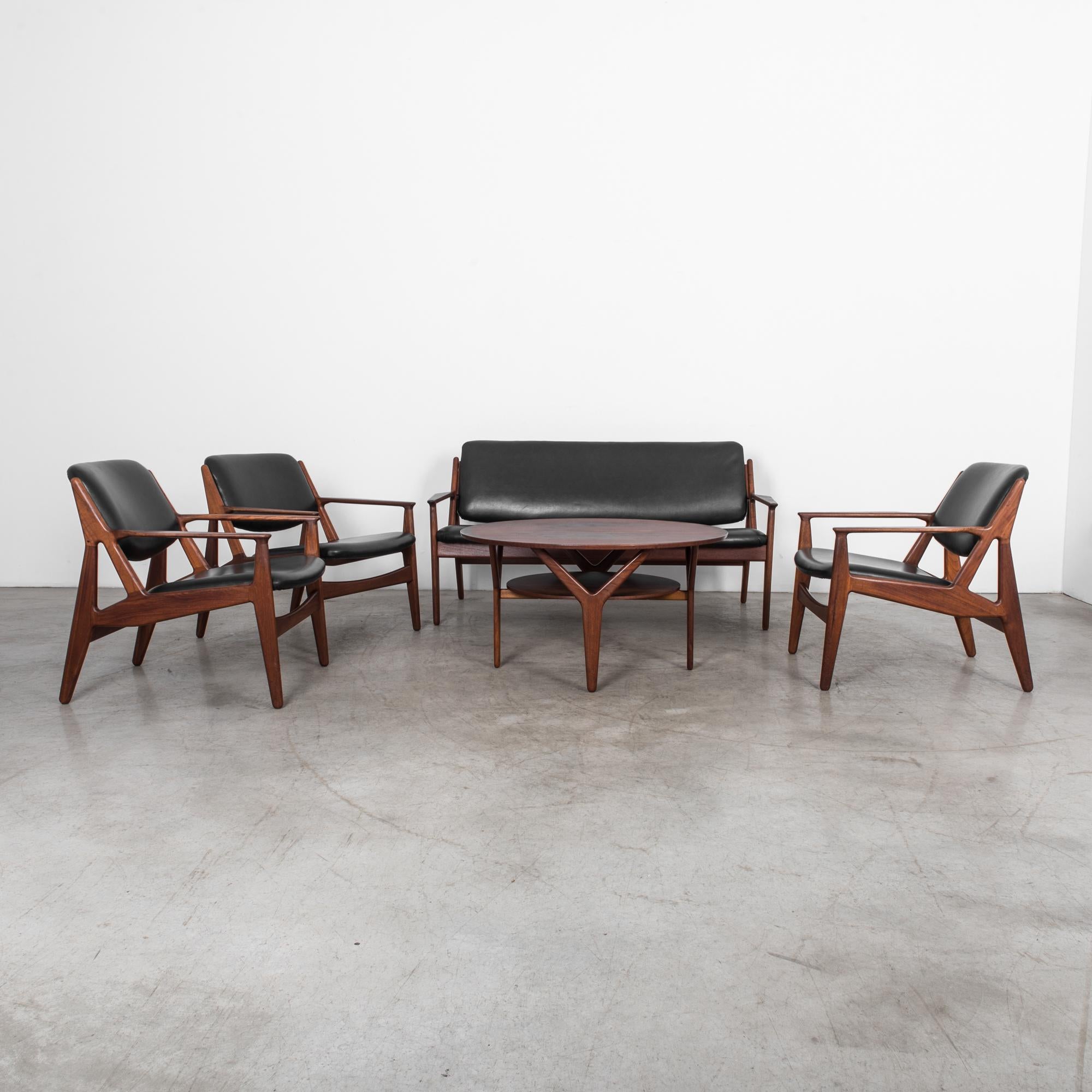 Set of five pieces by Arne Vodder, produced in Denmark, circa 1960. Three armchairs, sofa and table. A characteristic sleek midcentury design in teak. Masterfully finished with natural oils for a distinctive warm glow, highlighting the beauty of the