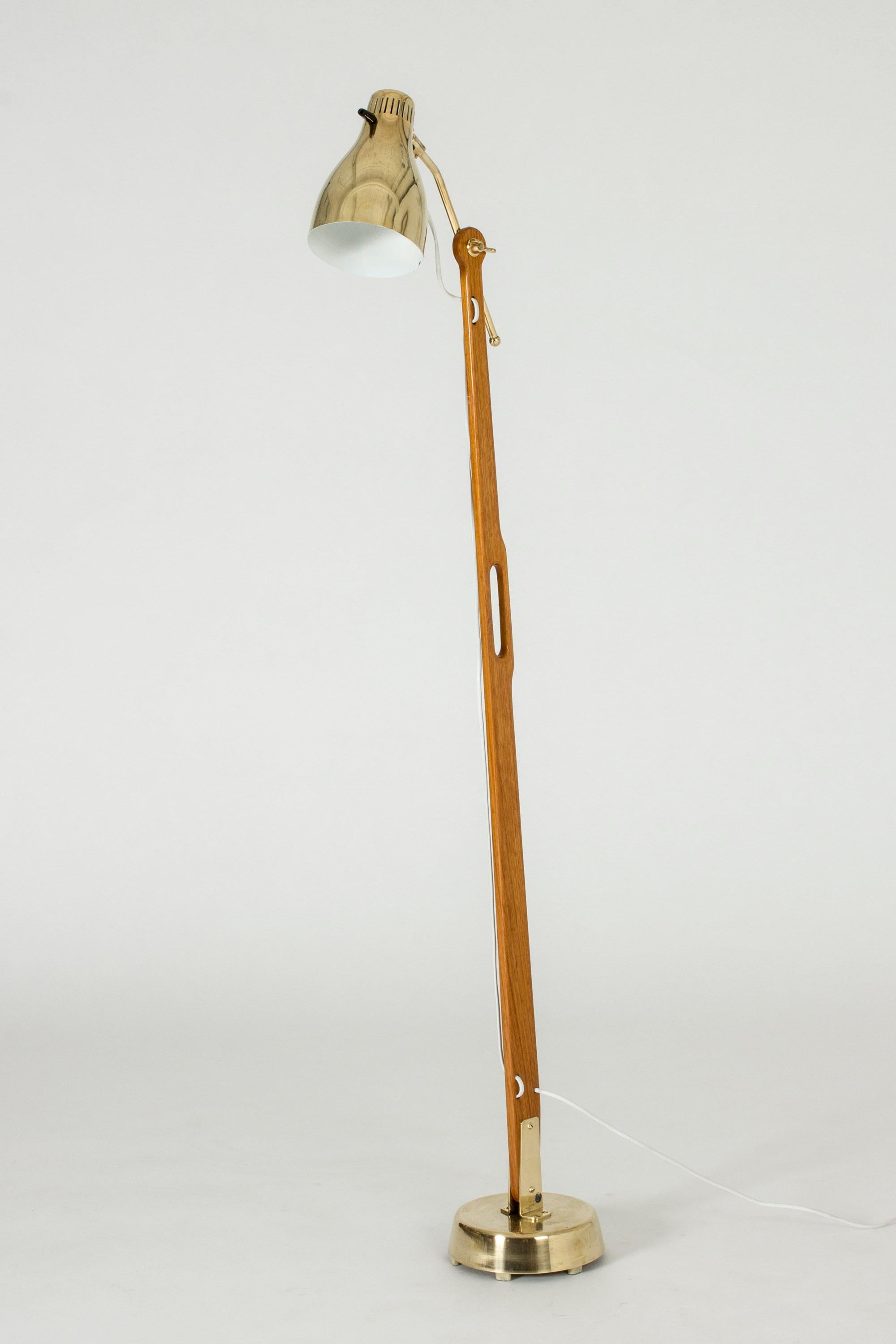 Amazing teak and brass floor lamp by Hans Bergström, with wonderful attention to detail and functionality. The lamp shade can be adjusted in different angles and at different distances from the pole. Handle crafted in the teak, making the lamp easy