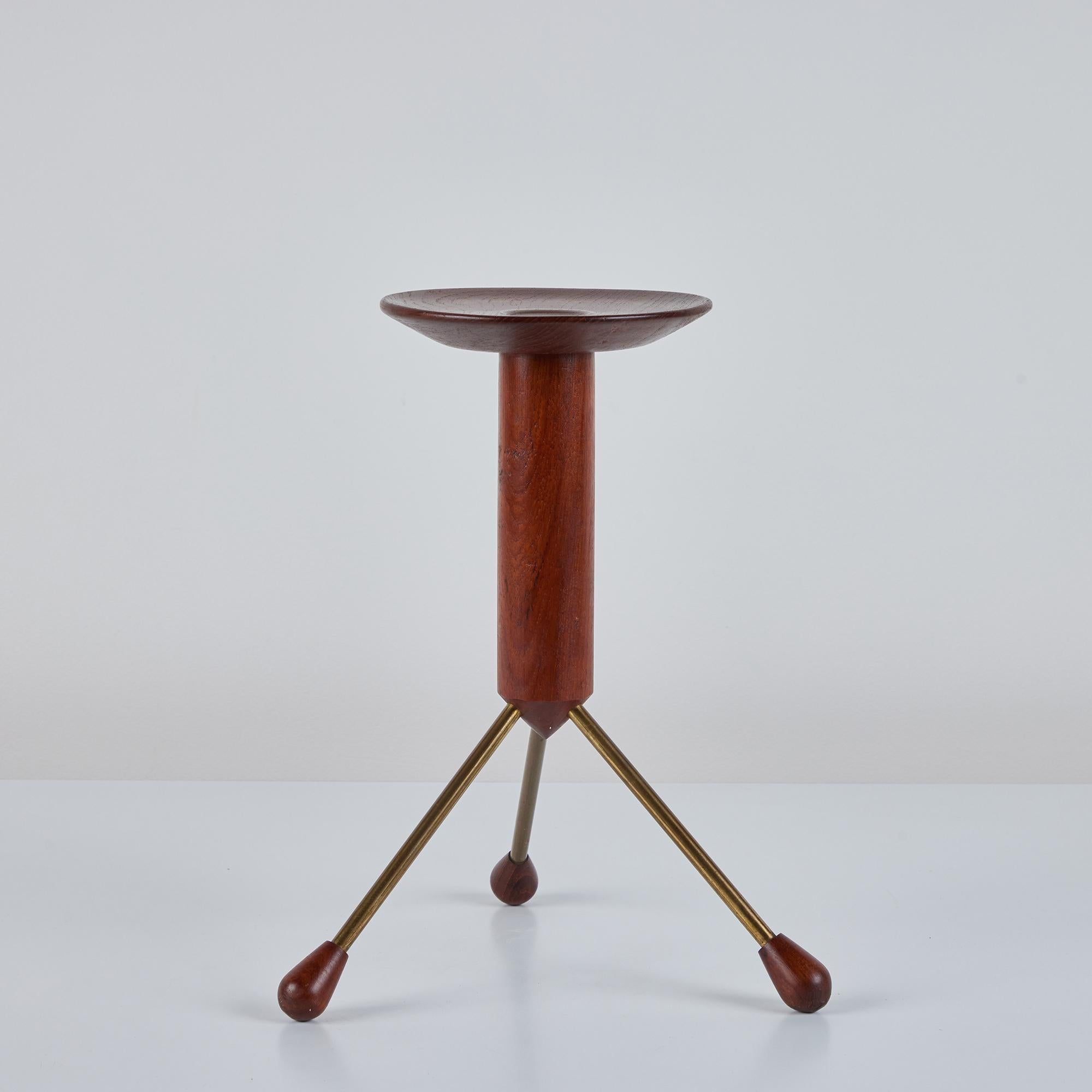 This teak tripod side table by Albert Larsson in and manufactured in Sweden by Alberts Tibro c.1960's. The teak top is supported by a teak shaft and three patinated brass flared legs, capped with a teak footing. The perfect petite table for an