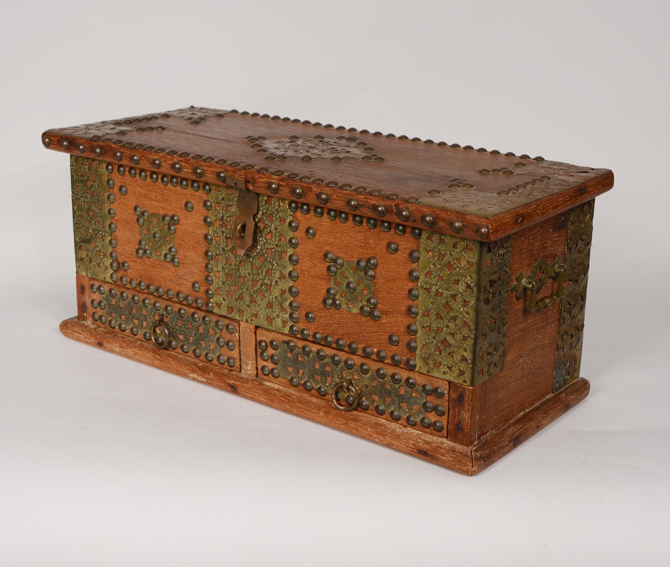 Small teak Zanzibar chest with brass studs. The chest has two compartments under the lid and two small drawers at the bottom. This was collected in Africa in the 1960's.