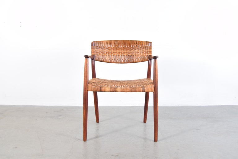 Teak and cane armchair, designed by Ejner Larsen & Aksel Bender Madsen. Produced by Willy Beck in Denmark, circa 1950s.

Arm height is 26 1/2