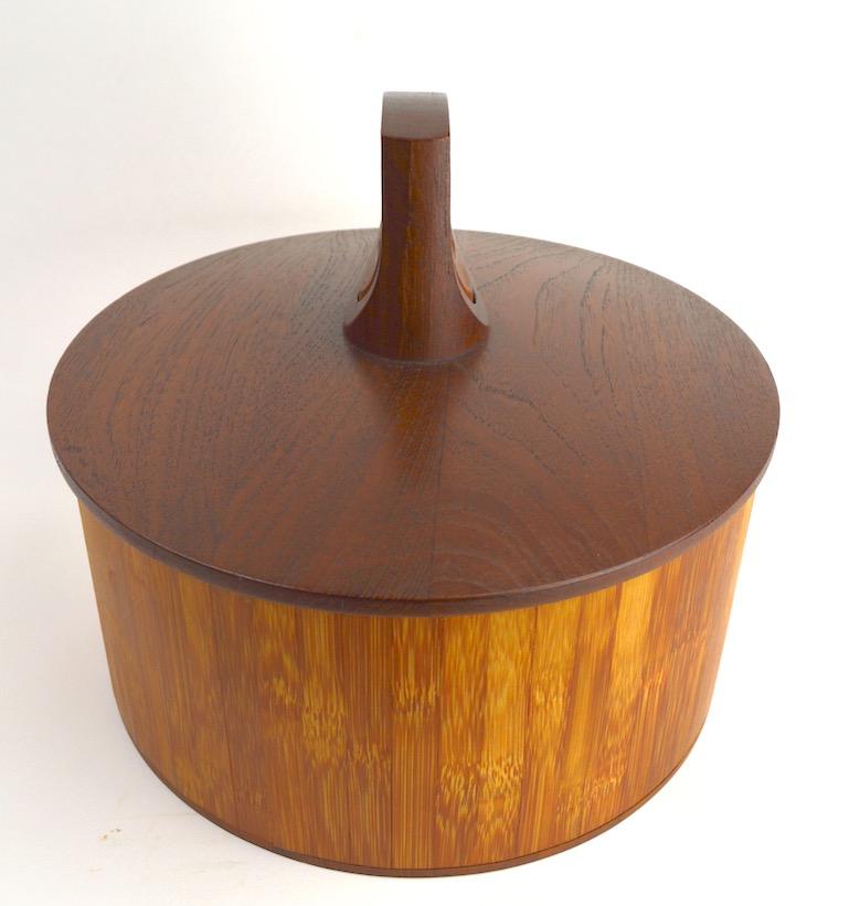 Rare model 1510 teak and cane ice bucket designed by Jens Quistgaard for Dansk. This example is in very good, original condition, clean and ready to use, or just display. Sophisticated architectural form, with early Dansk Ducks mark. A hard to find