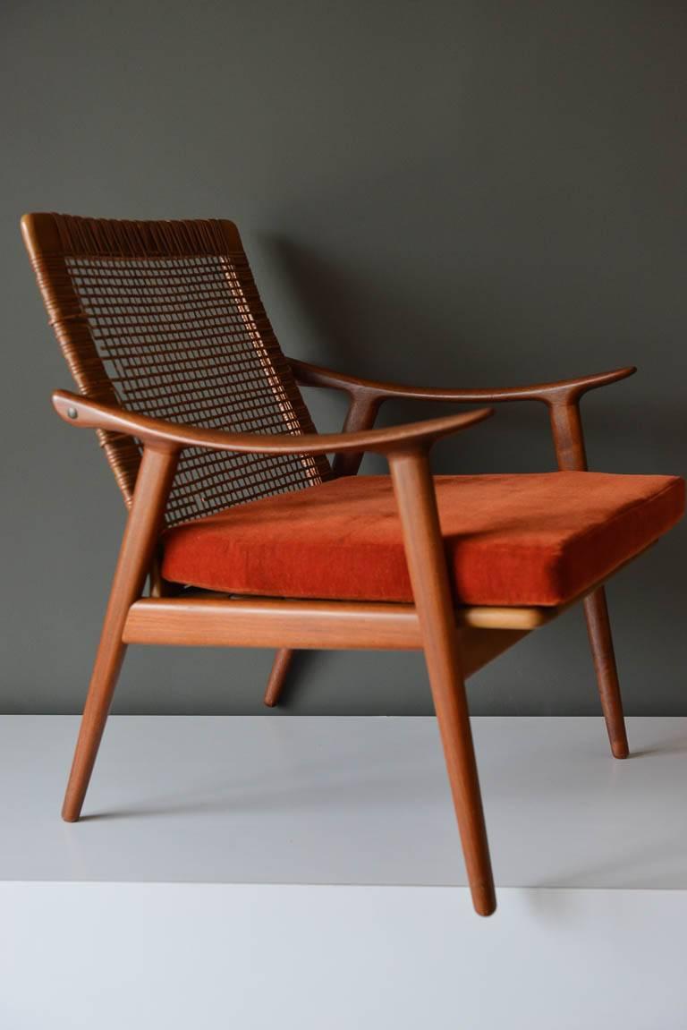 Teak and Cane Lounge Chair Model 571 by Fredrik Kayser, for for Vatne Lenestolfabrikk, Norway, ca. 1960.  Original condition with original orange velvet cushion in good condition.  Seat springs are excellent with no breaks.  Cane has some wear, as