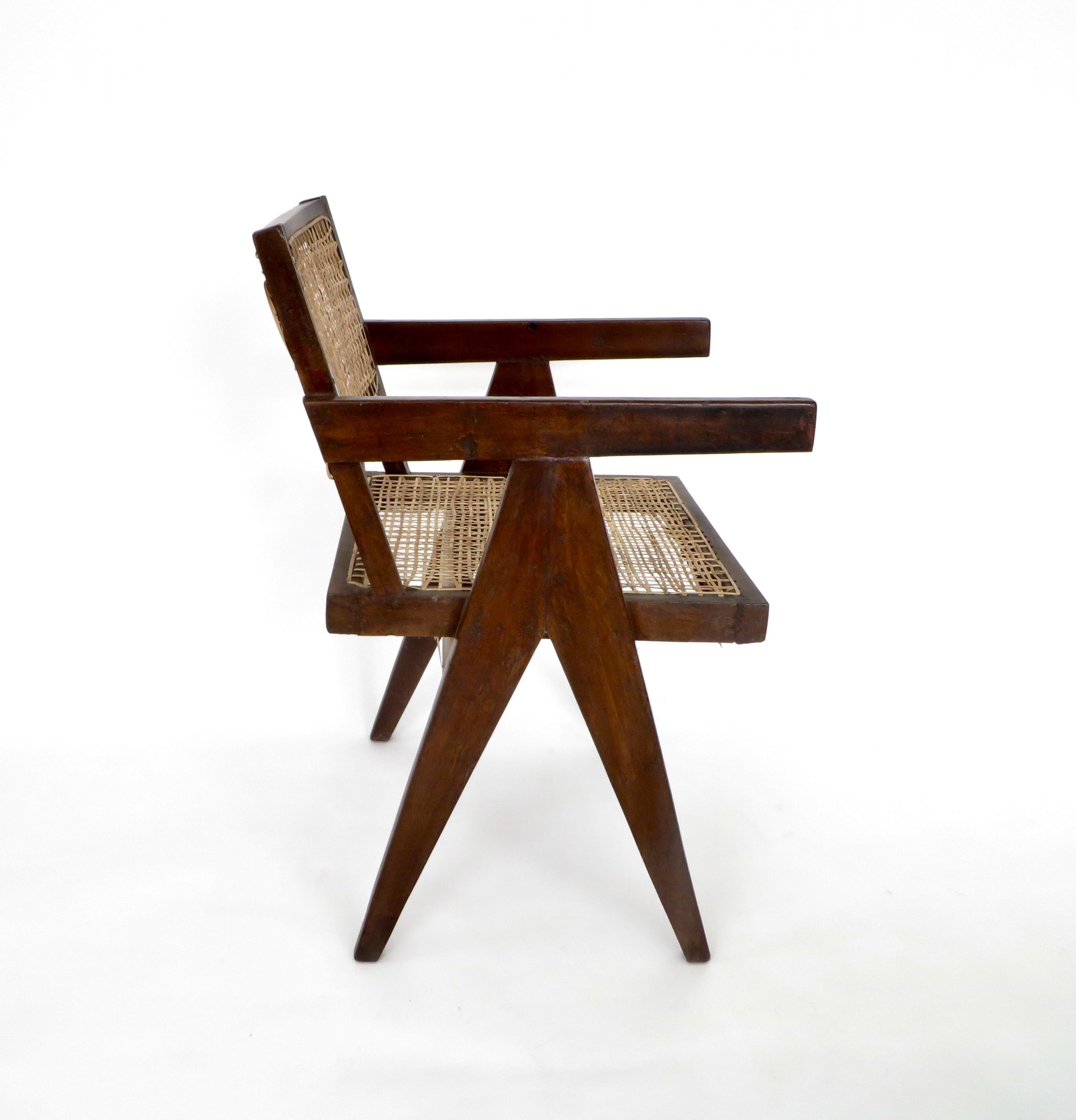 A single armchair called office cane chair by Pierre Jeanneret (1896-1967) from Chandigarh.
In teak with cushion and with bended and slightly curved back.
Cane seat and back, circa 1956.
This example has been restored with a wax finish.
Signs of