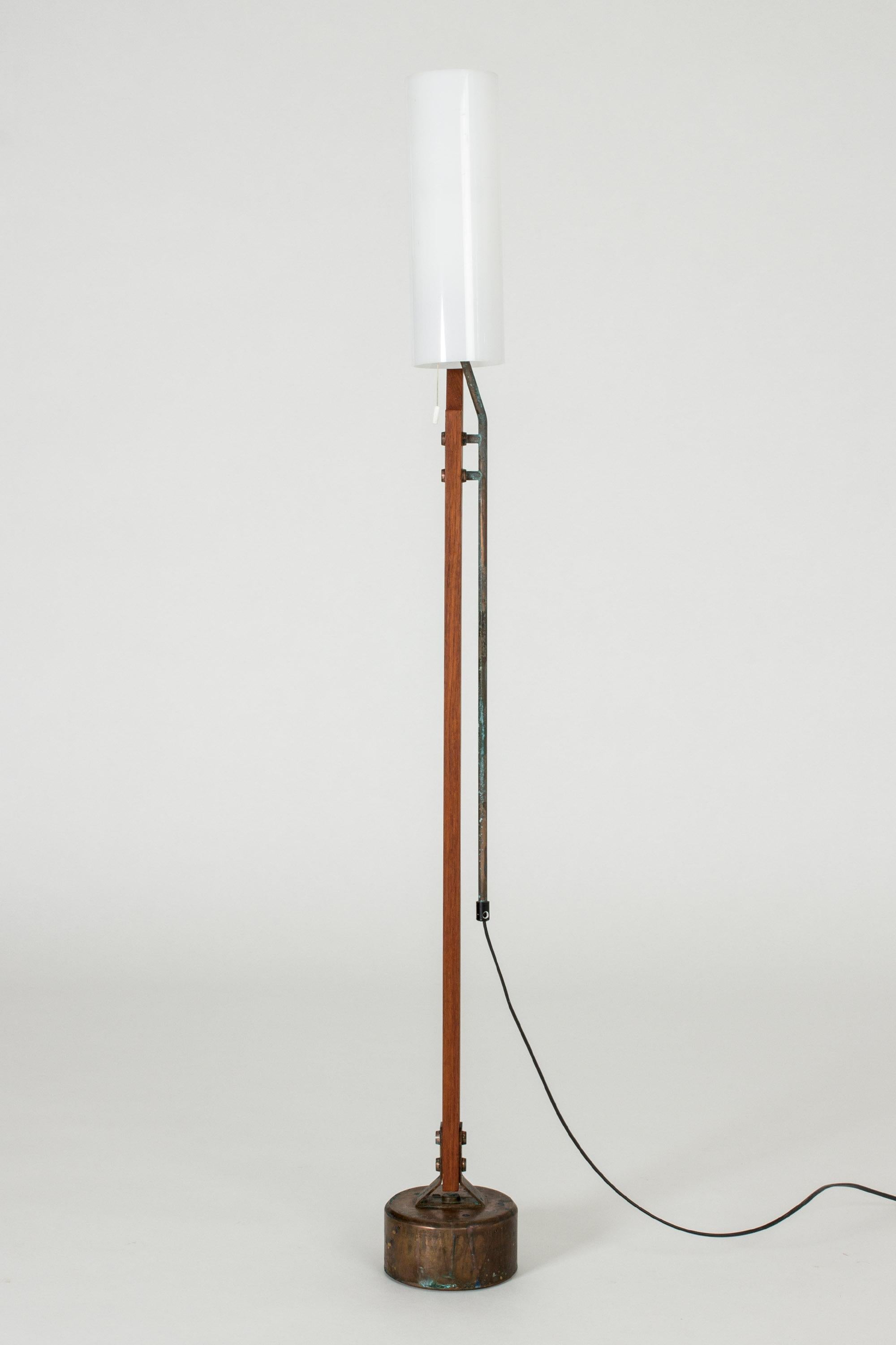 Very cool floor lamp from Orrefors, with a teak handle and copper base. The wiring runs through a copper pipe on the outside of the handle for a bit of an industrial effect. Cylinder shaped shade made from acrylic.