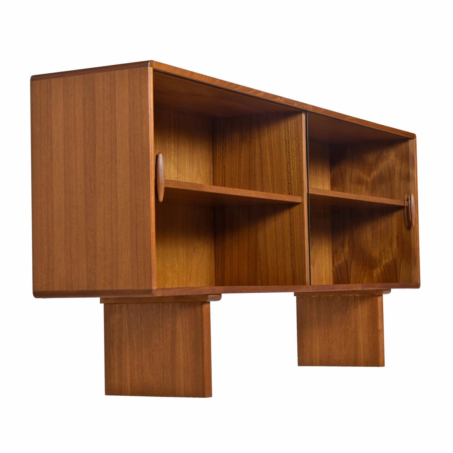 Midcentury Scandinavian Modern Danish teak bookcase console cabinet credenza by Dyrlund. Made in Denmark, vintage 1970s, teak wood construction. The unit is finished on back side and can be used as a room divider. This credenza as a prime example of
