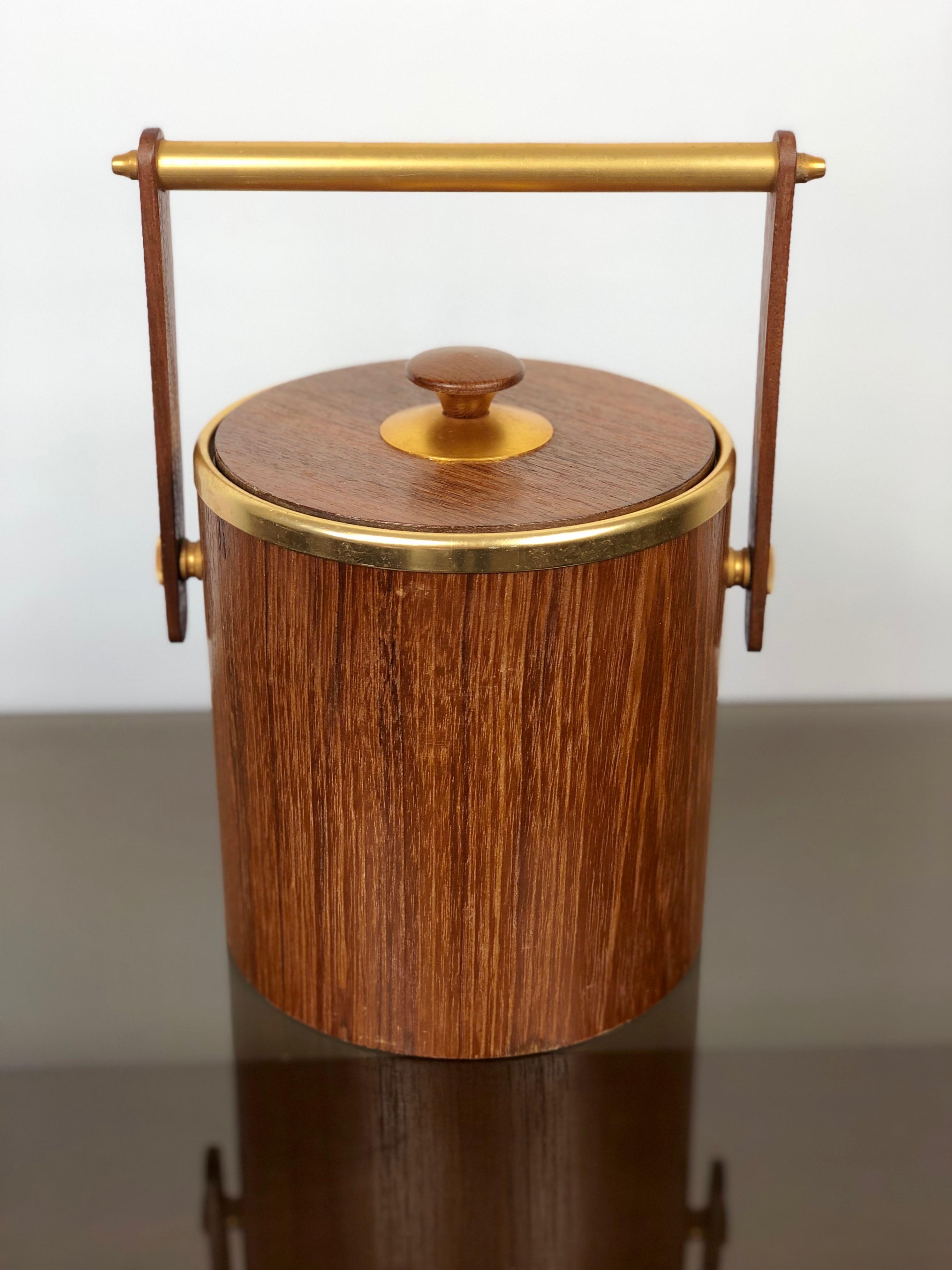 Italian ice bucket in teak and gold metal details, circa 1960s. 

The 