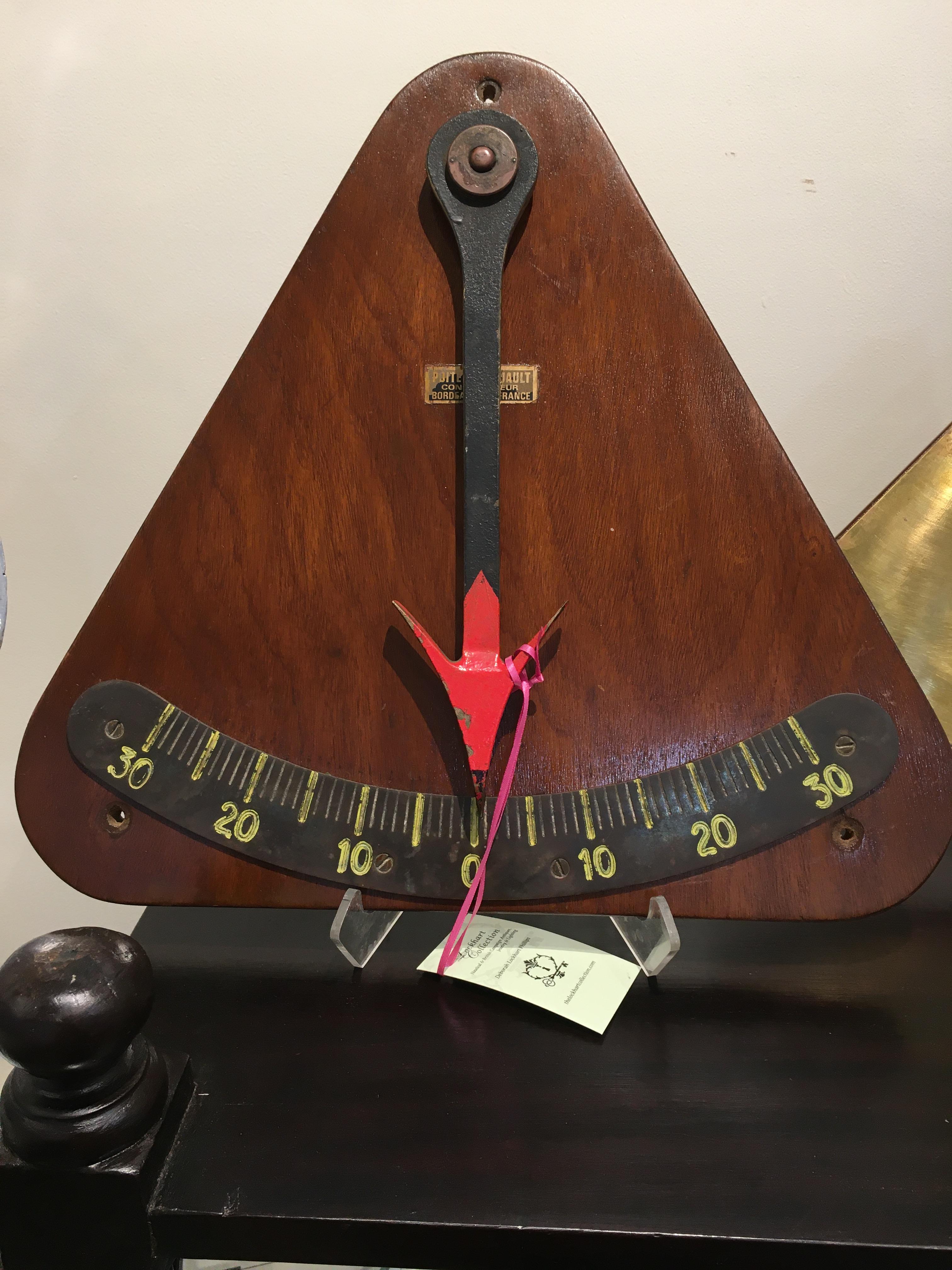 A ship's clinometer of teak and iron with original paint. Used to measure the degree of healing on a boat, or on larger boats to weigh the distribution of cargo to be sure the ballast is even. Midcentury, Bordeaux, France. By Pointvin Duault