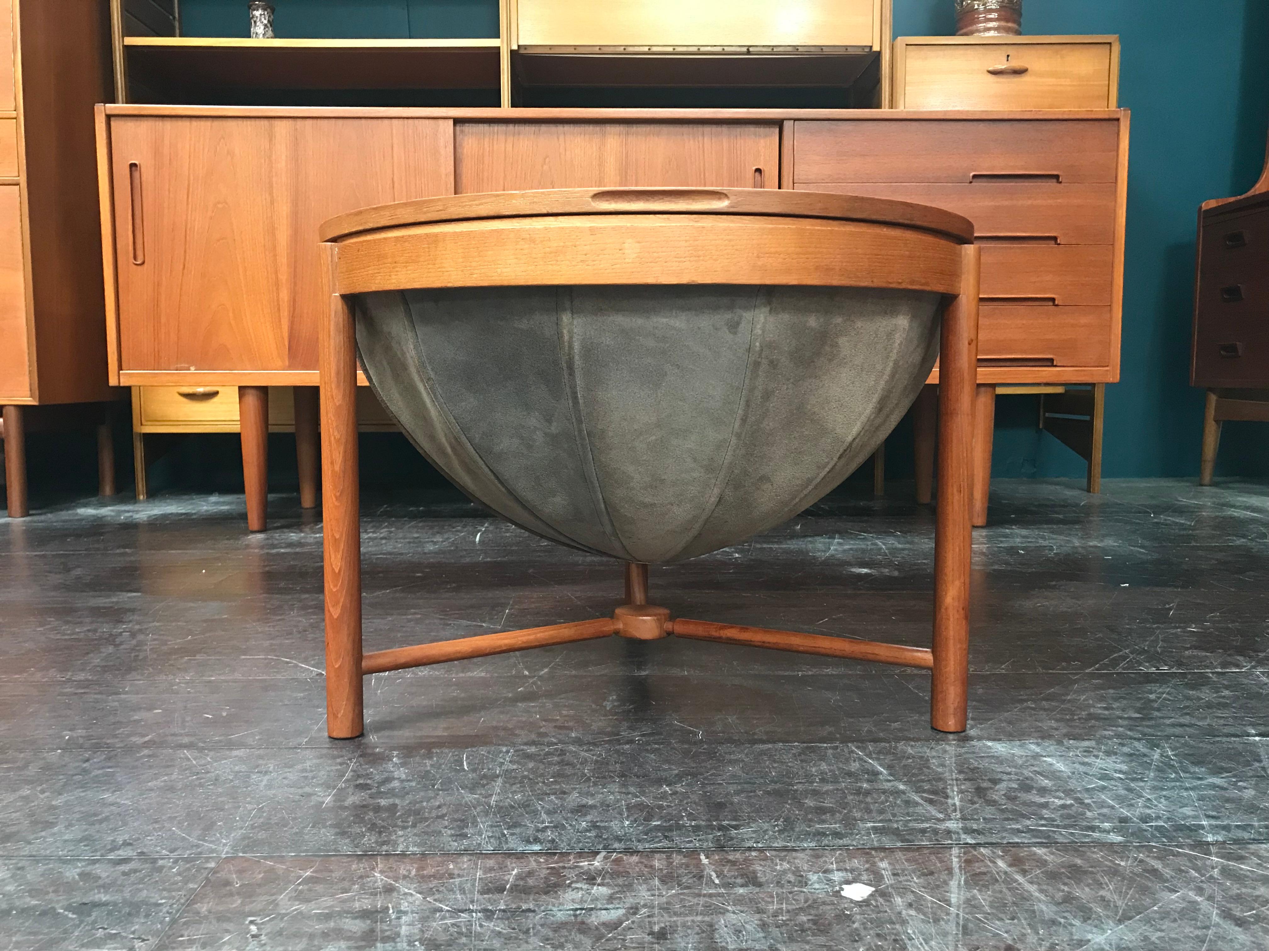 This is a vintage Norwegian design round sewing table in teak with storage basket that offers a rare chance to own a highly desirable piece of midcentury design. This little sewing table is beautifully made and can be used for a variety of purposes.