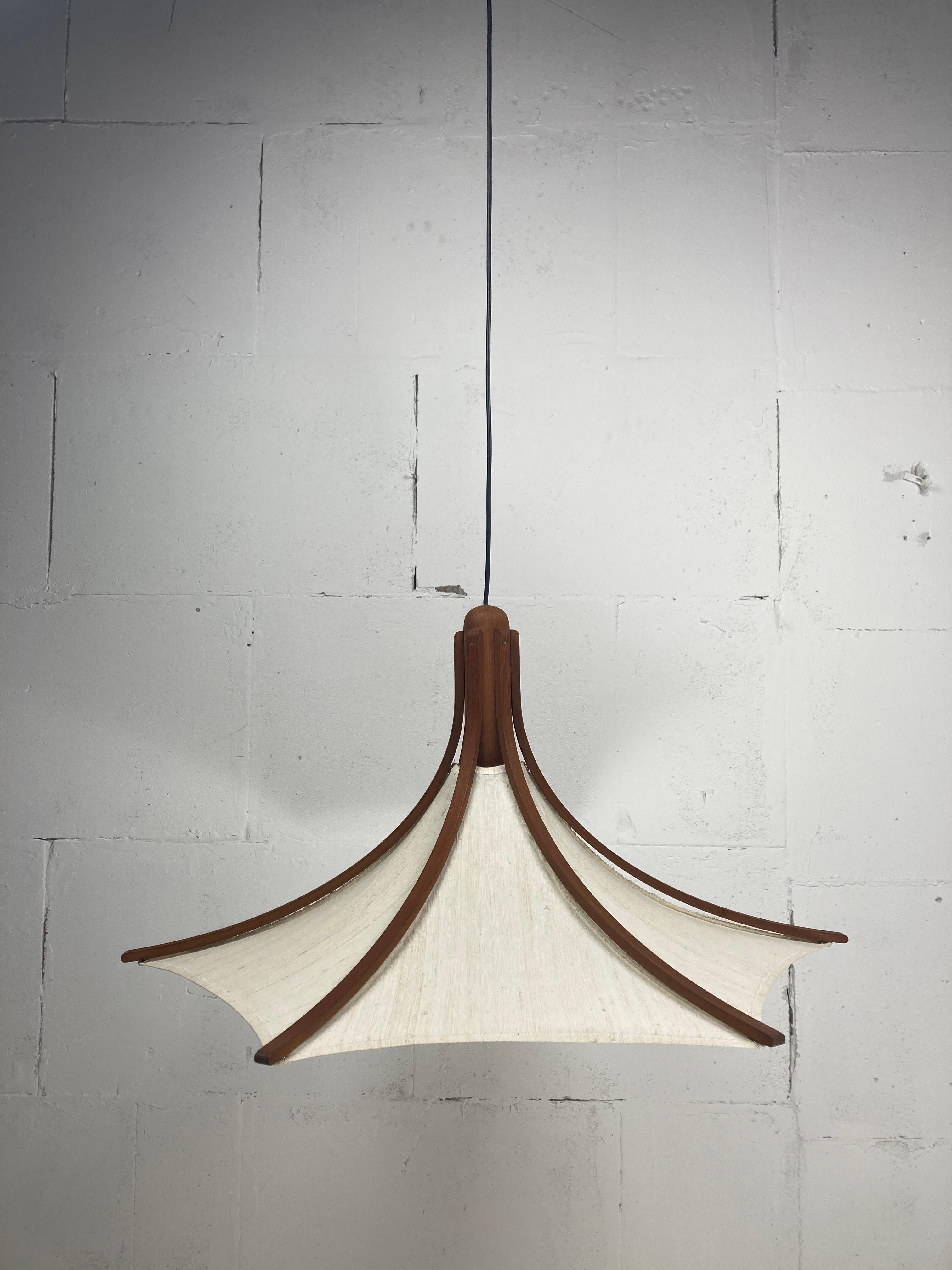 This is the largest version of the umbrella pendants by domus in teak and linen ( 81 cm wide and roughly 39 cm in height ). The linen is detachable and also washable if you would need to but its in perfect condition. We will also be listing some