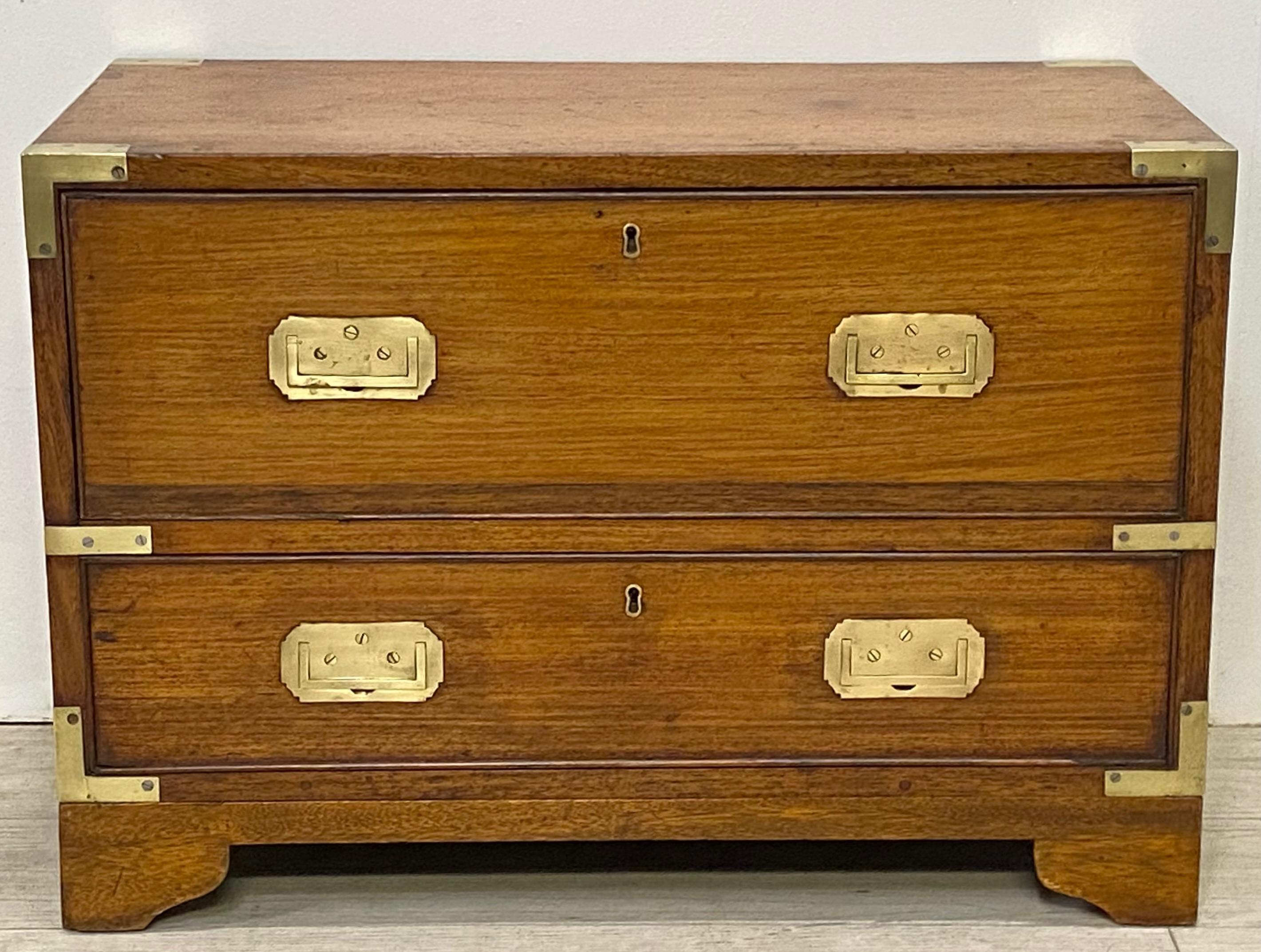 Teak wood Campaign style chest converted to a coffee table, having a mahogany fitted interior with a replaced leather writing surface, and original recessed brass hardware.
Made in China for the European English market. Early 19th century.
Chest