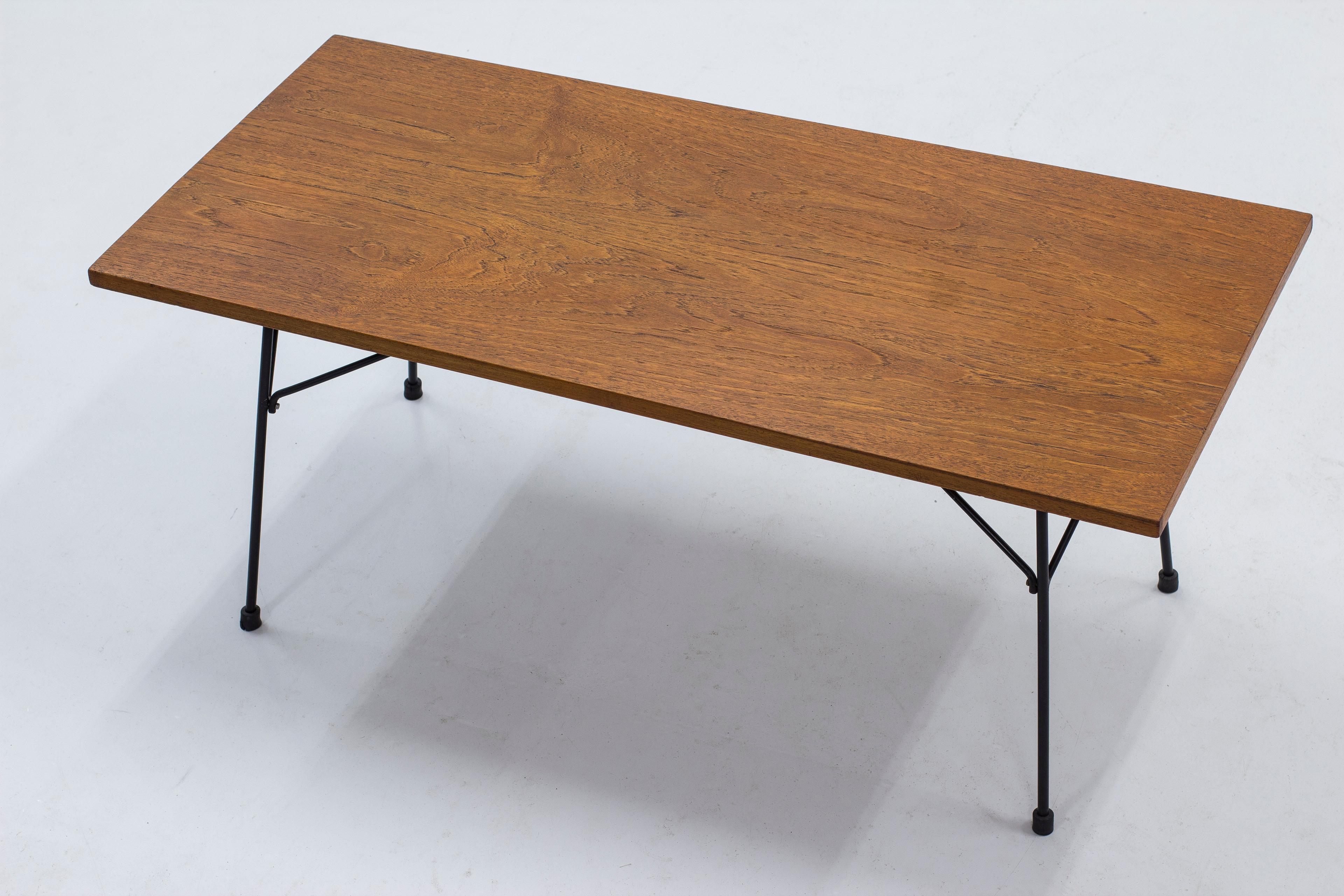 Rare sofa table designed by Hans-Agne Jakobsson. Early production from his own company when they were established in Åhus, Sweden. Done sometime during the 1950s. Black lacquered metal base with a teak table top. Good vintage condition with age
