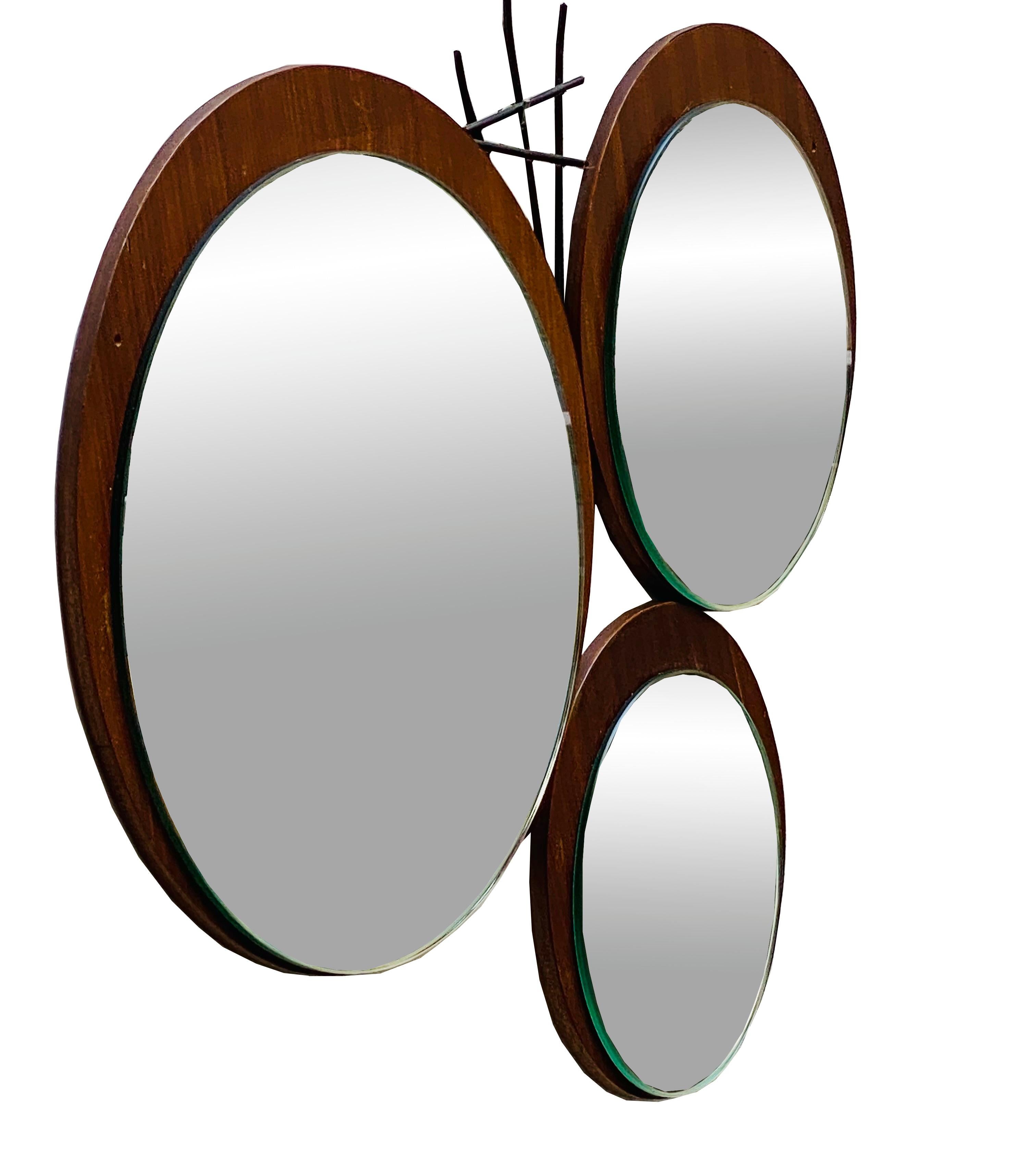 Unique wall mirror with three panes of glass mounted on a teak wood base and wrought iron insert, Italian production 1960. Small holes in the wood visible in photo.



