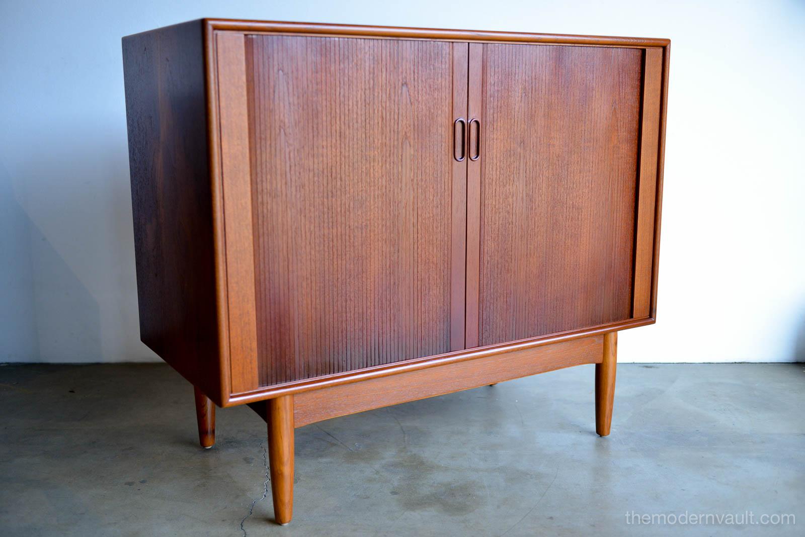 Teak and Oak Tambour Door Cabinet by Hans C. Andersen, circa 1965. Imported to the U.S. by Gunnar Schwartz of Los Angeles. Teak tambour doors with oak base. Professionally restored in perfect condition. Adjustable shelves on the inside and a small