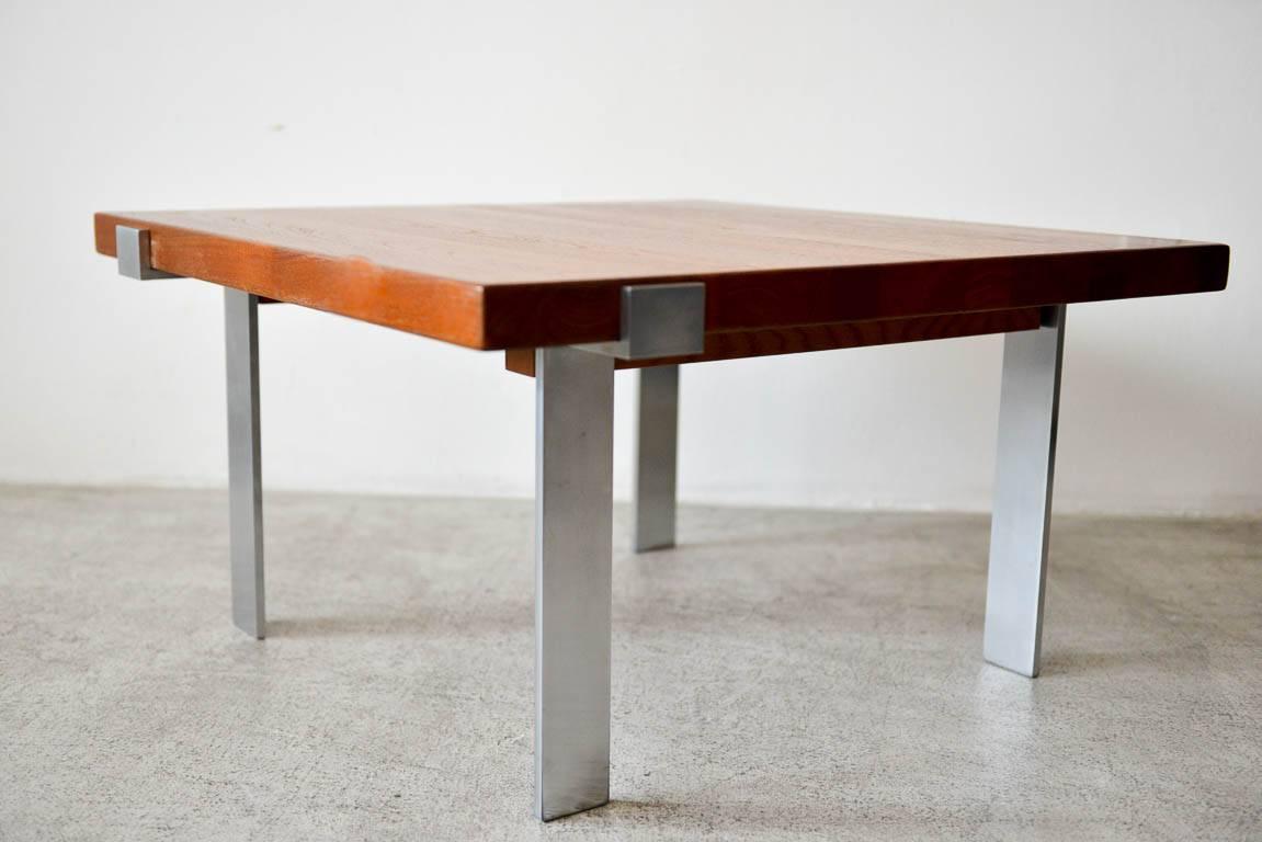 Teak and steel coffee table by Mikael Laursen for Illum Wikkelso, circa 1960. Solid staved teak table designed by Illum Wikkelsø for A. Mikael Laursen. Poul Kjaerholm design influence with wide flat bar brushed stainless steel legs that are set off