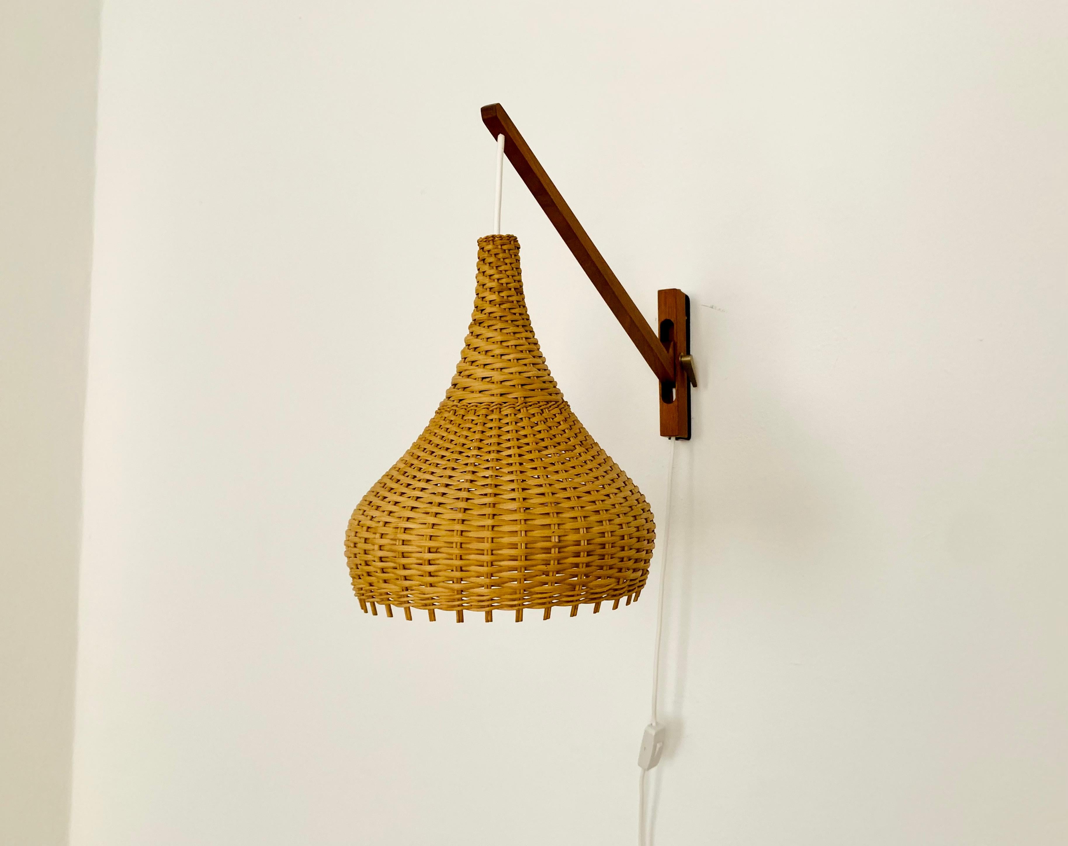 Wonderful Danish teak wall lamp from the 1960s.
Great and exceptional design with a fantastically elegant look.
The rattan lampshade creates a very cozy atmosphere and a spectacular play of light.

Condition:

Very good vintage condition with slight