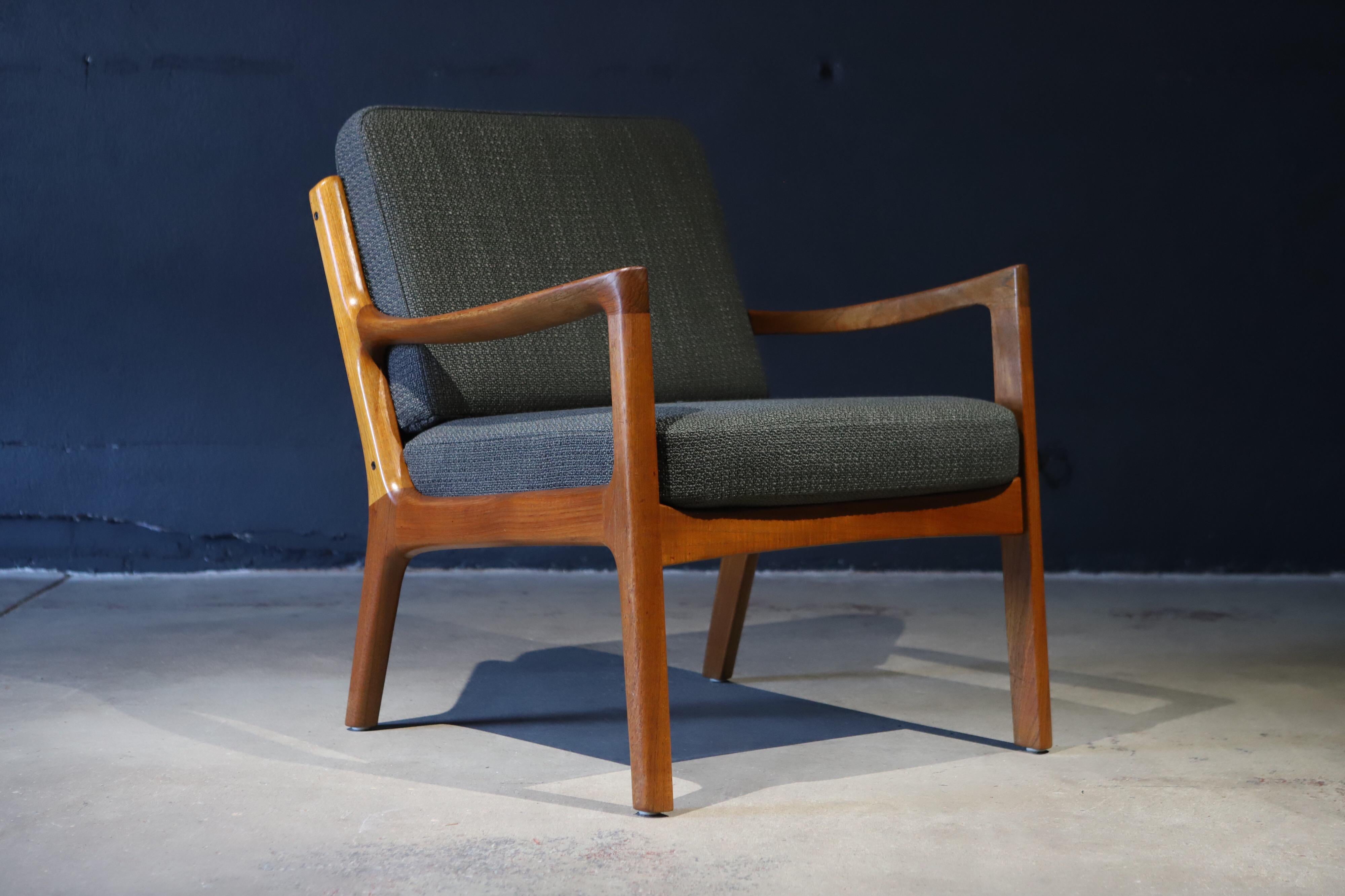 An absolutely stunning Danish teak armchair by Ole Wanscher for France & Sons, Denmark. Photographed with Ole Wanscher sofa and biomorphic cocktail table for scale.