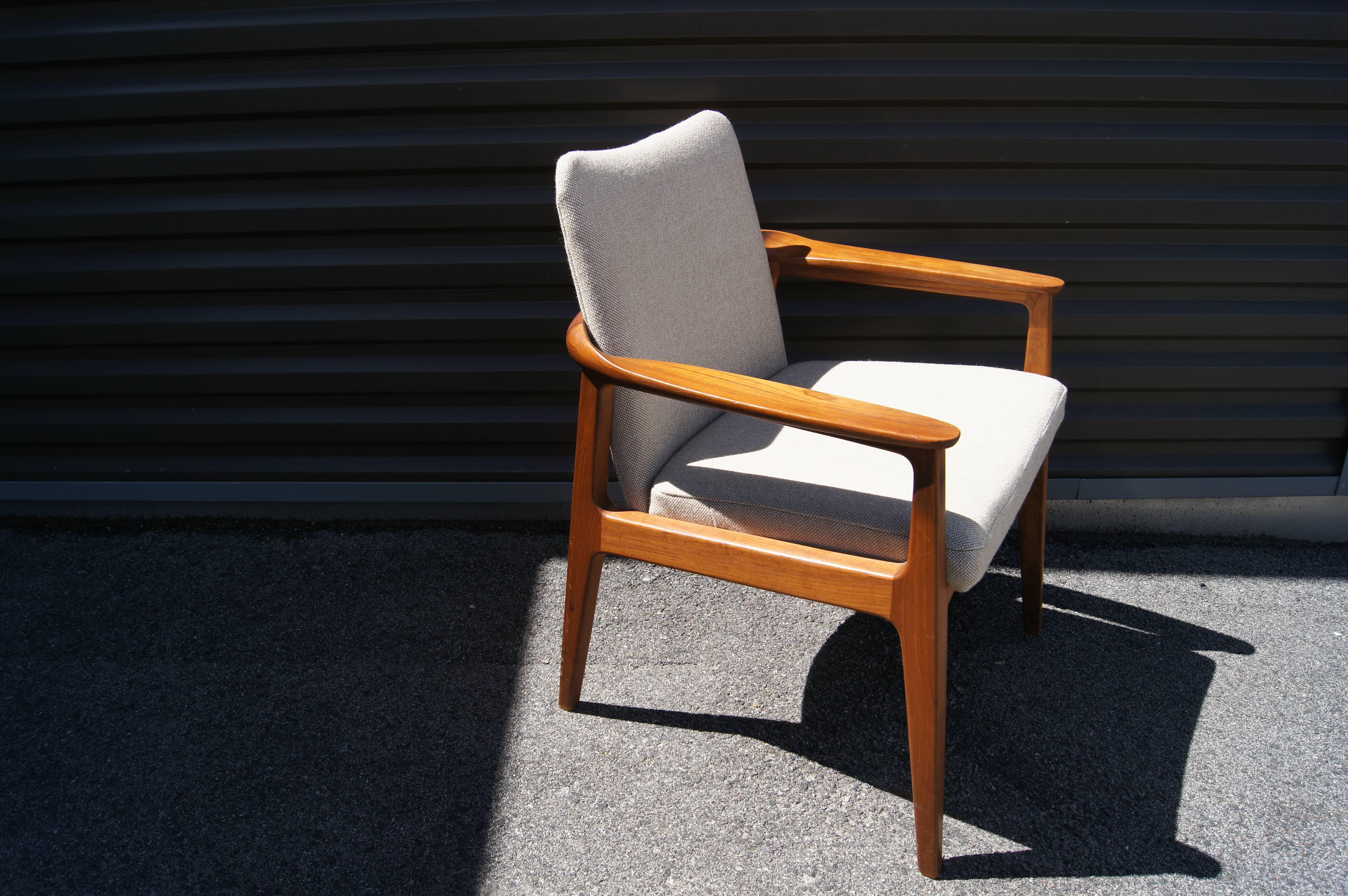 Created by Swedish designer (and member of the royal family) Sigvard Bernadotte, this armchair features a solid teak frame, with lovely joinery details, whose rounded back flattens to paddle arms. It has been reupholstered in Maharam's Hallingdal by