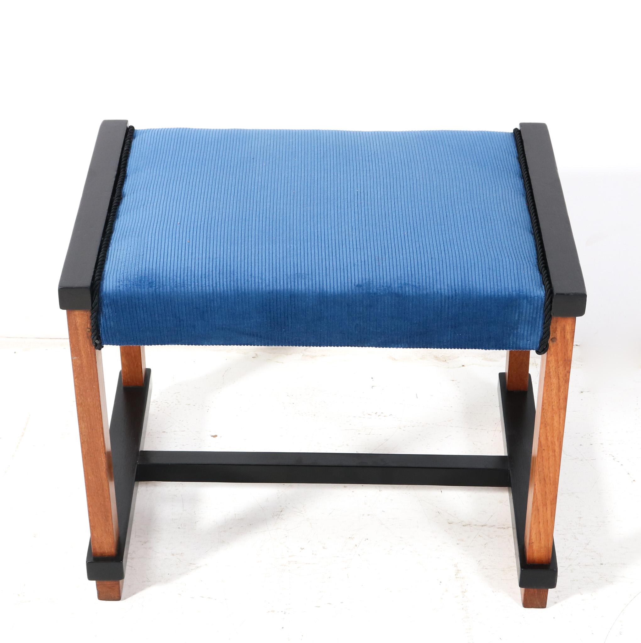Stunning and rare Art Deco Modernist stool.
Design by Hendrik Wouda for H. Pander & Zonen Den Haag.
Striking Dutch design from the 1920s.
Solid teak frame with original black lacquered elements.
The top is re-upholstered with a blue Manchester