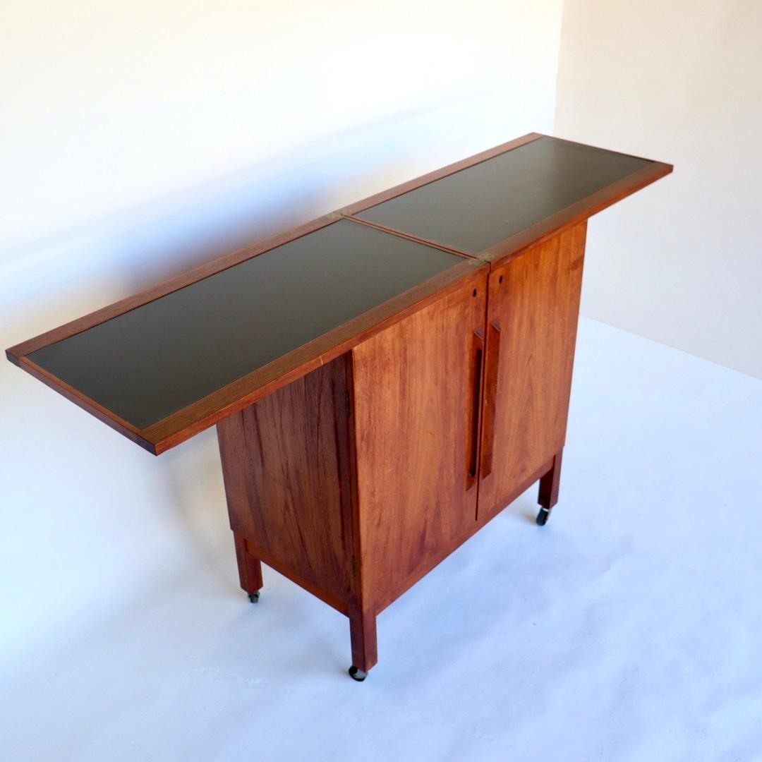 *Price includes restoration. Pictures depict piece before restoration*

Absolutely beautiful and functional Mid-Century Modern “flip top” teak, bar cabinet/ cart by Torbjorn Afdal for Mellemstrands Mobelfabrik / Bruksbo of Norway, circa 1960s.